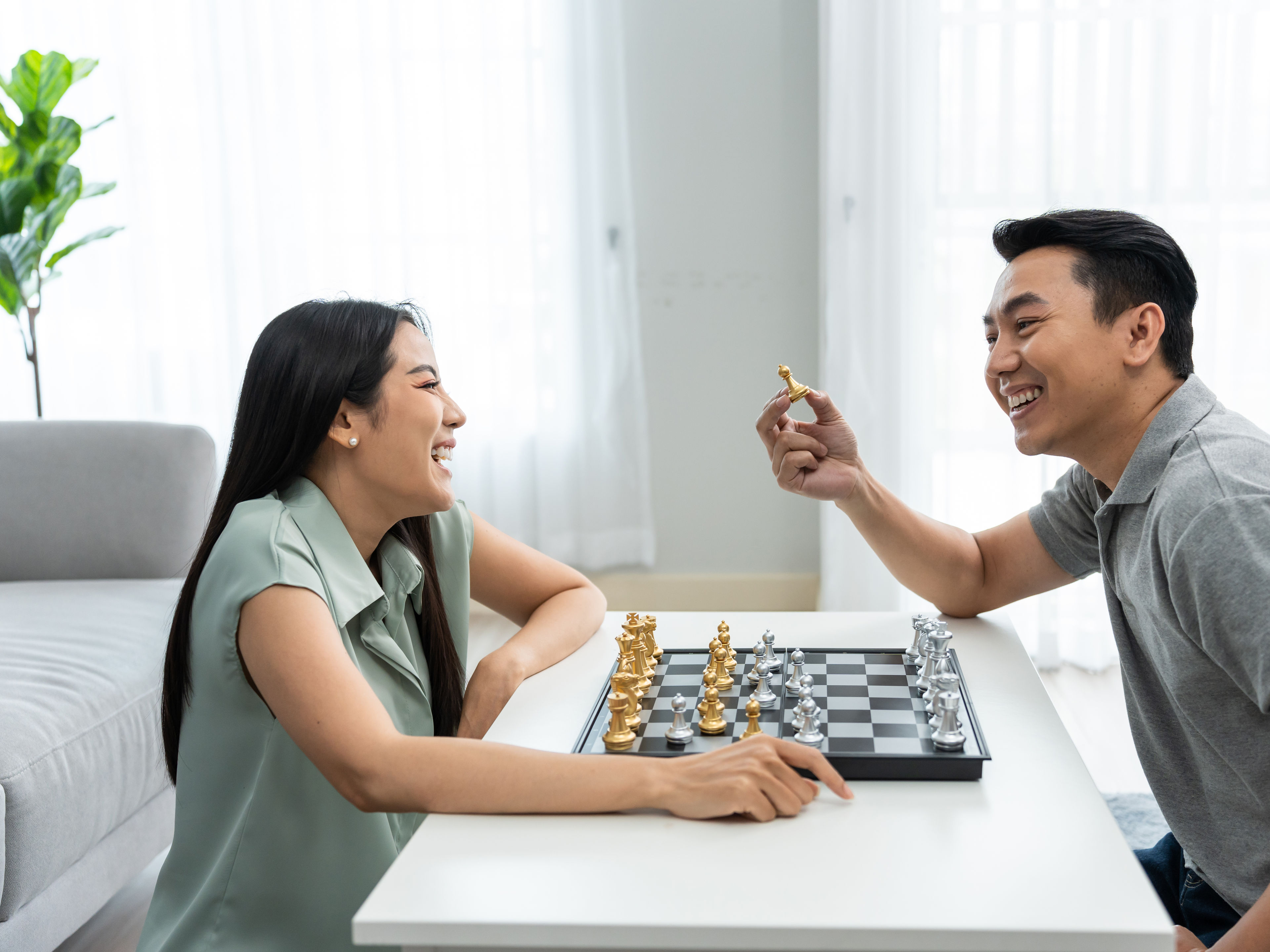 A couple playing chess together. 