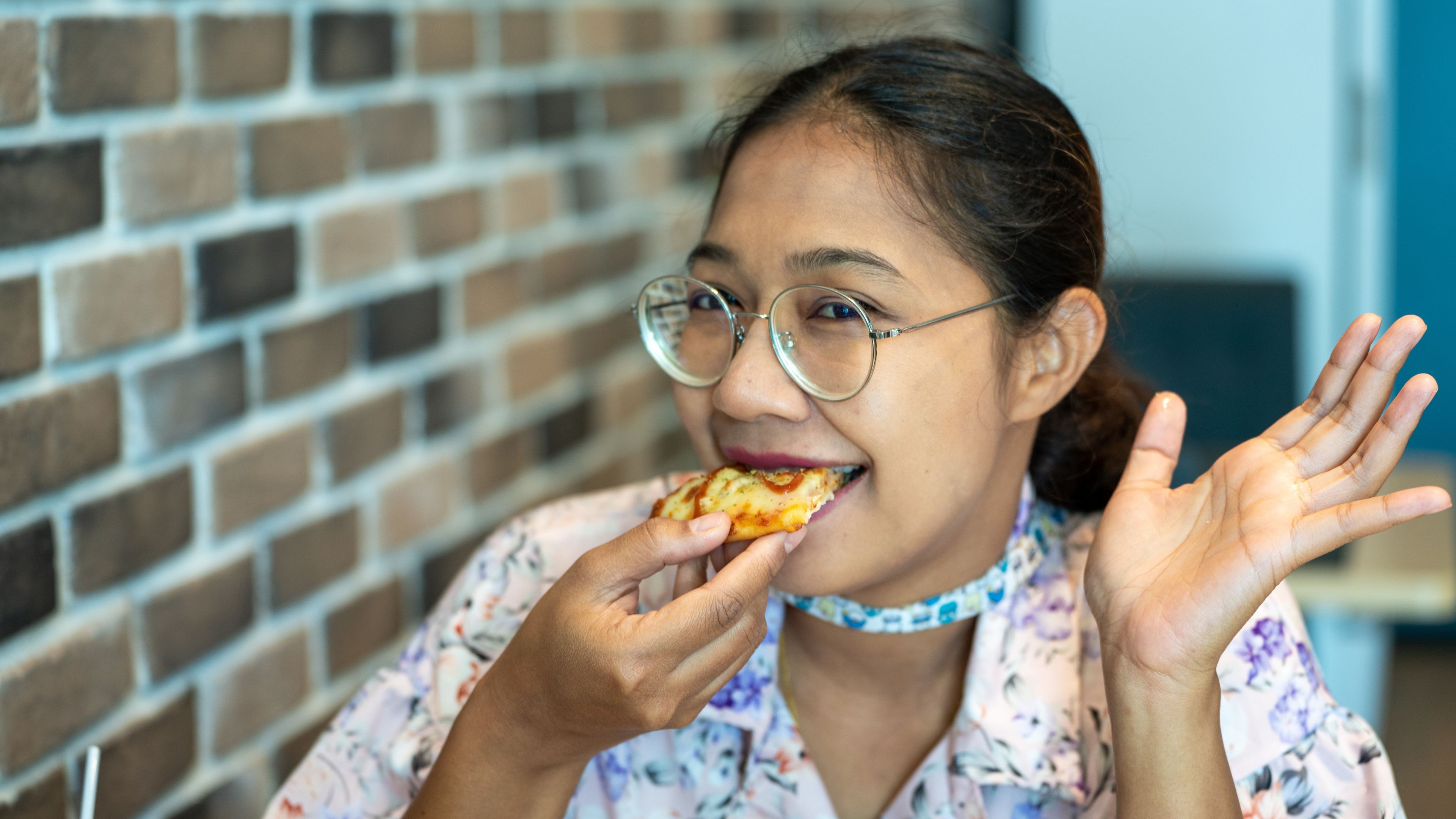 A woman eating pizza