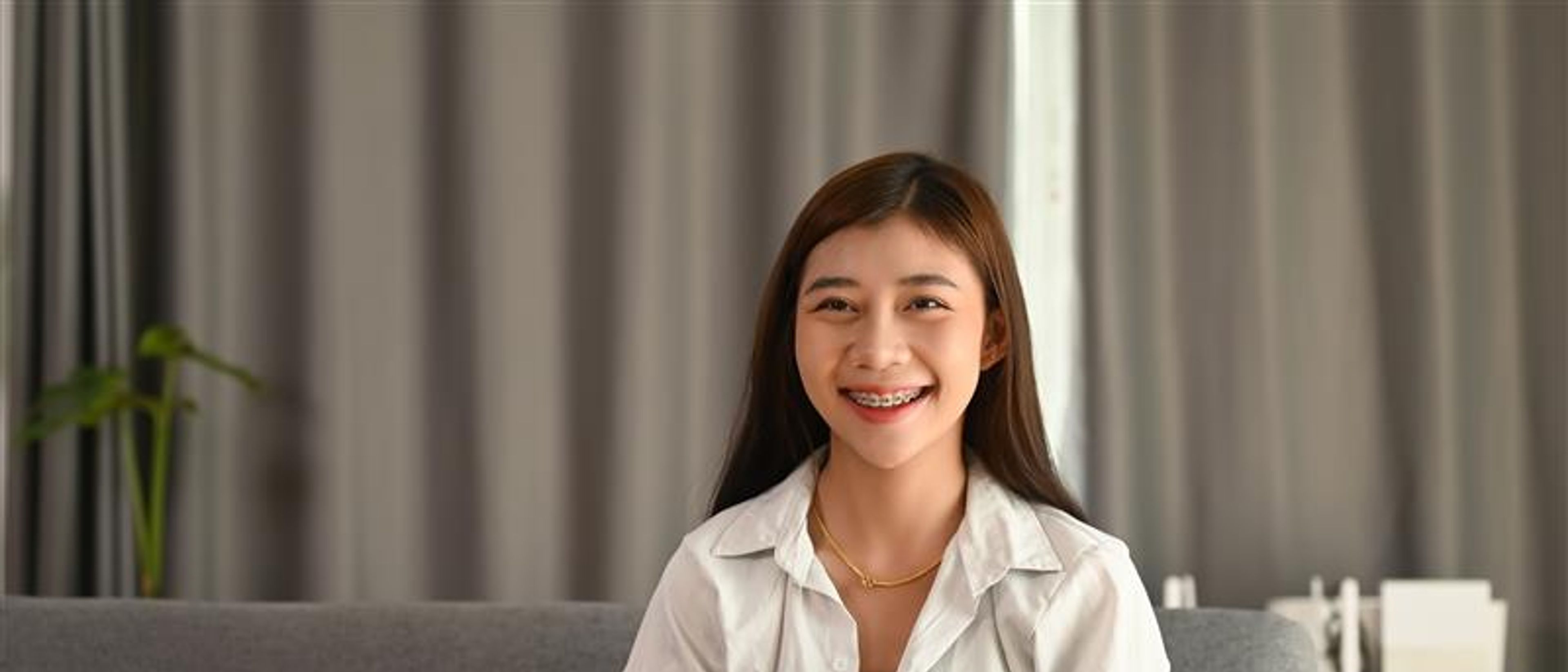 A young woman holding joy stick and playing video games