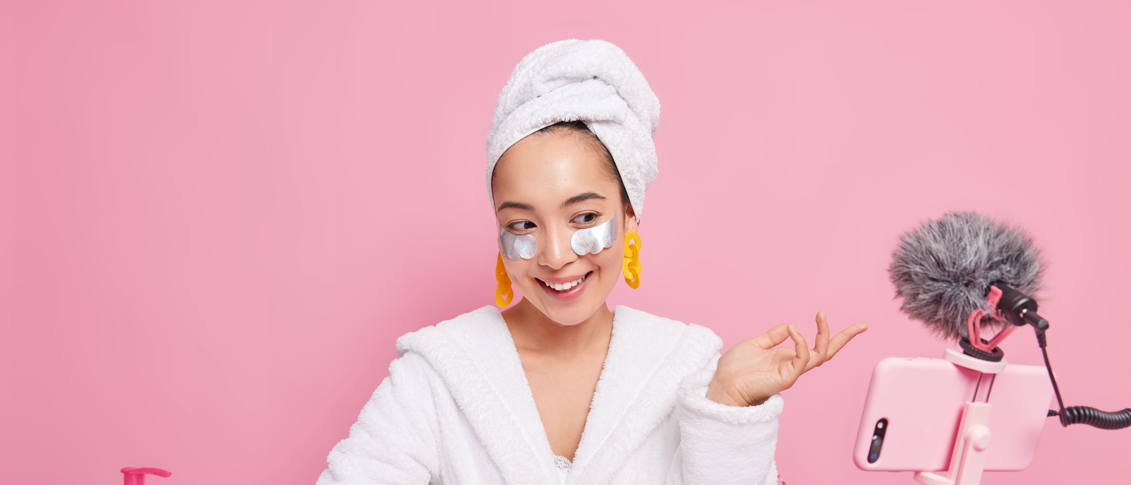 Beautiful Asian lady with healthy skin talks with followers online records video for blog applies be