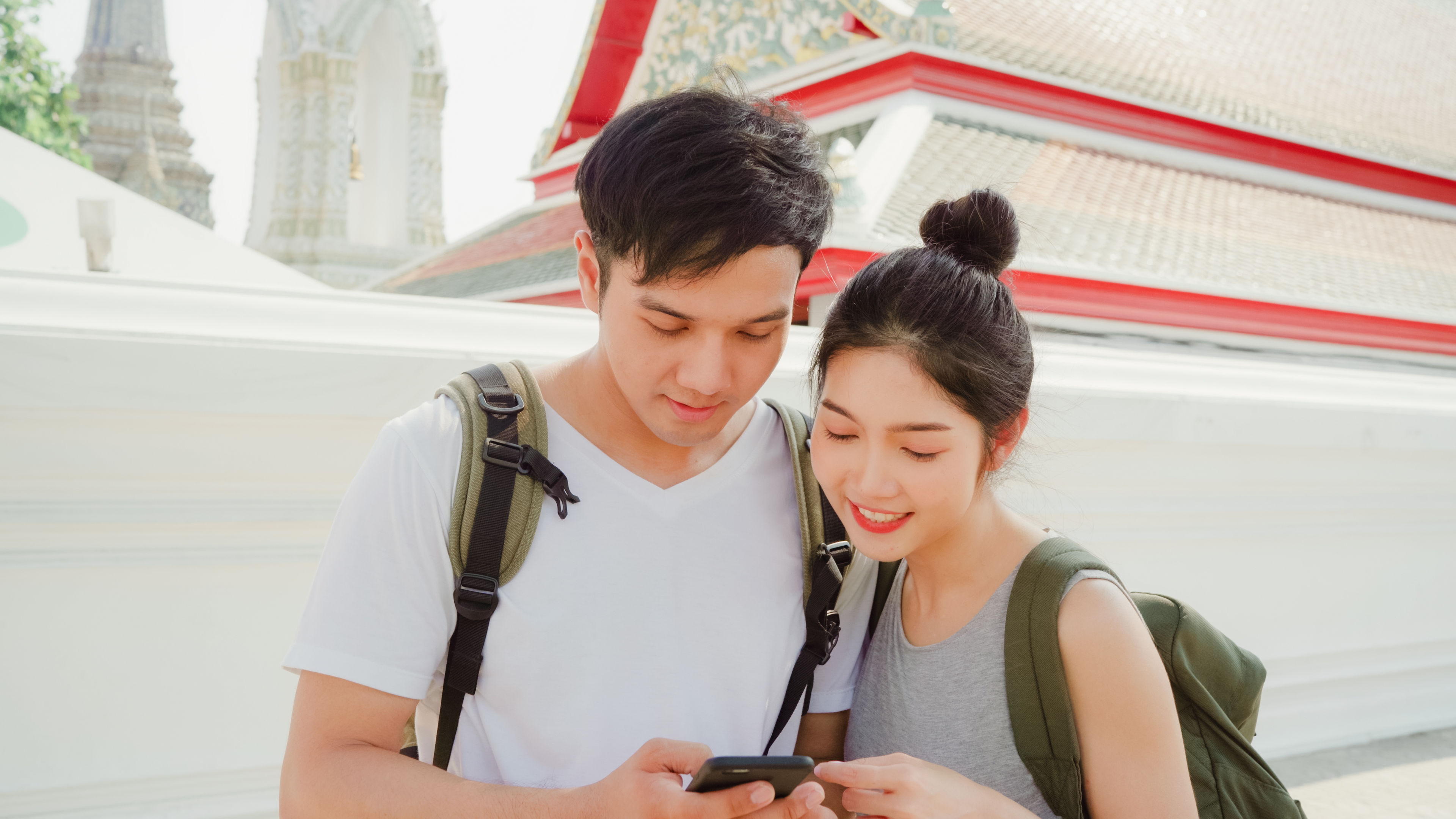 couple using mobile phone looking on map
