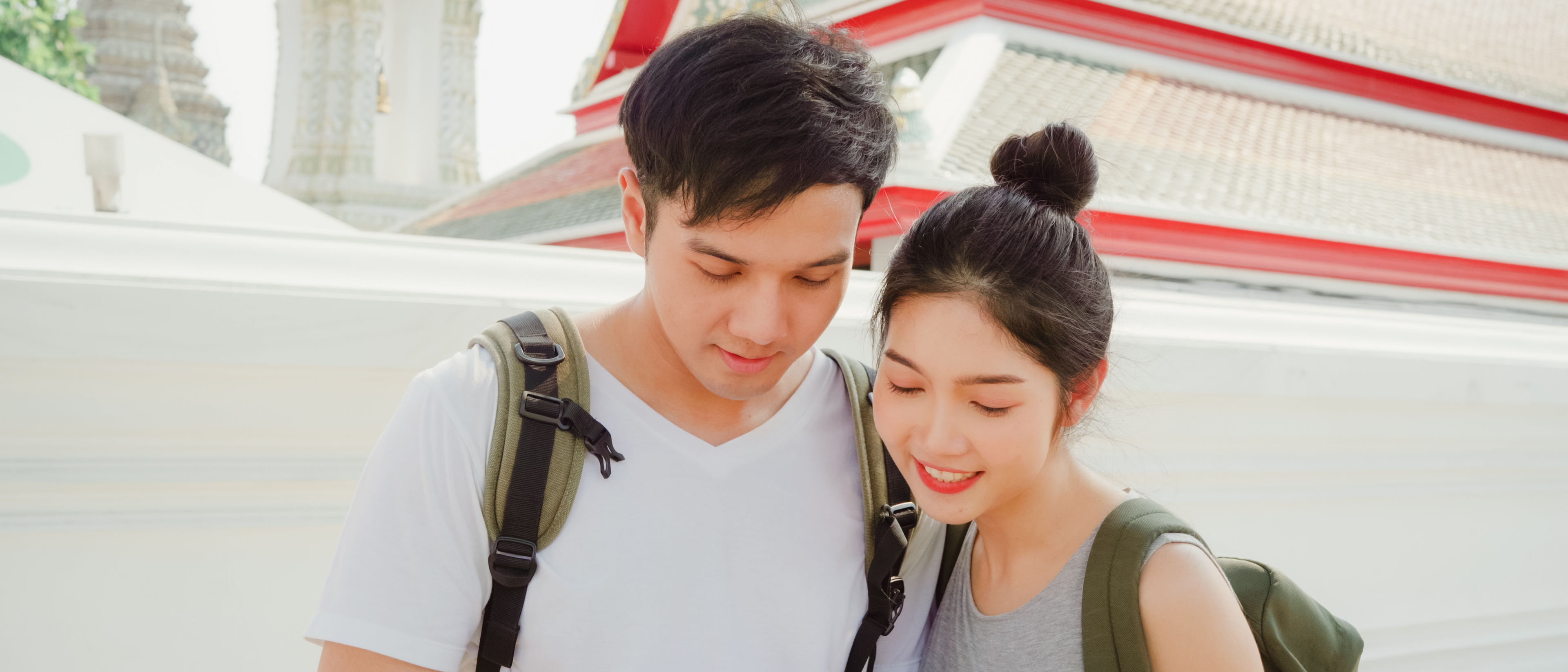 couple using mobile phone looking on map  