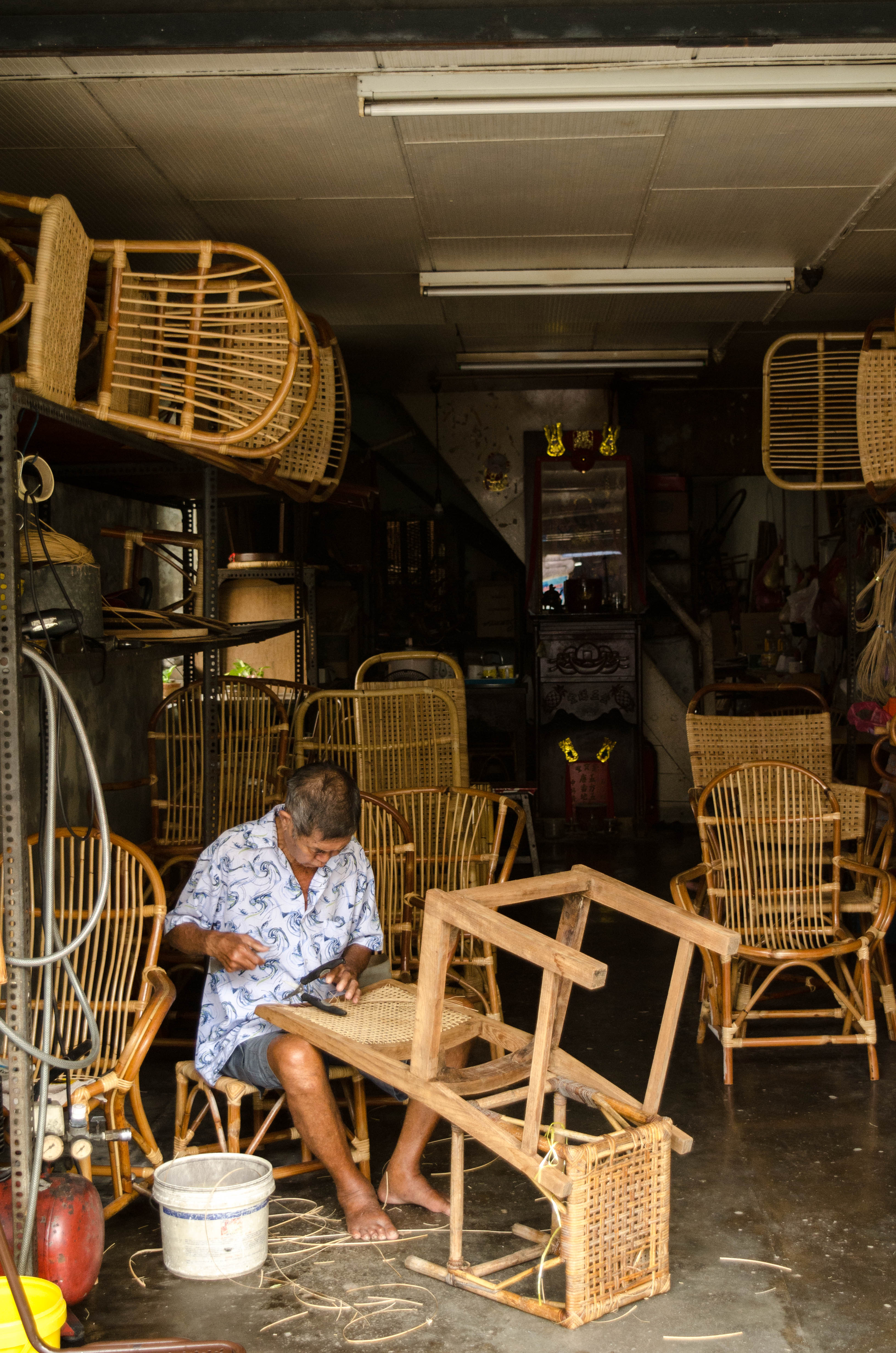 Old man making wooden furniture 