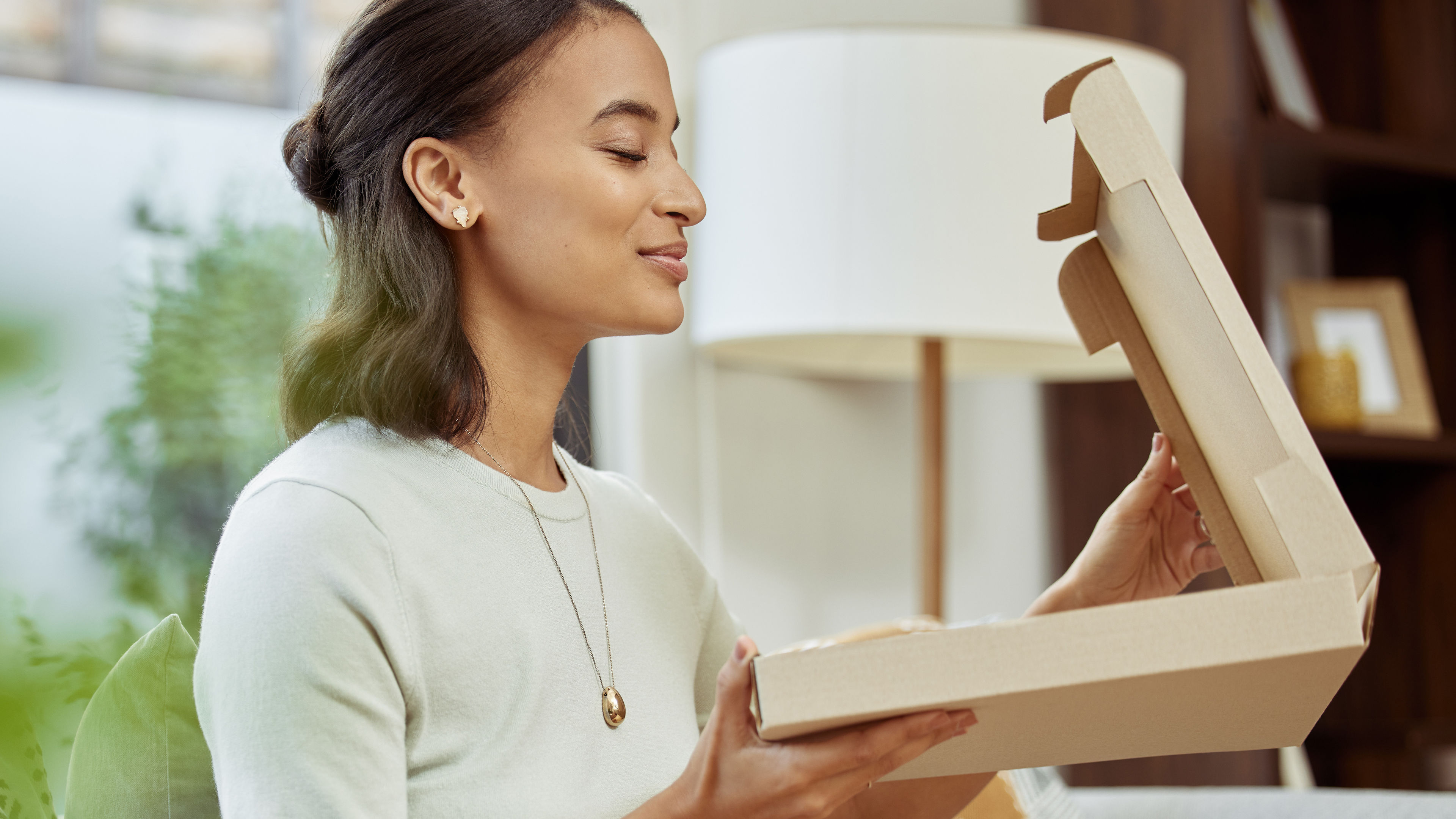 The woman opening food delivery box