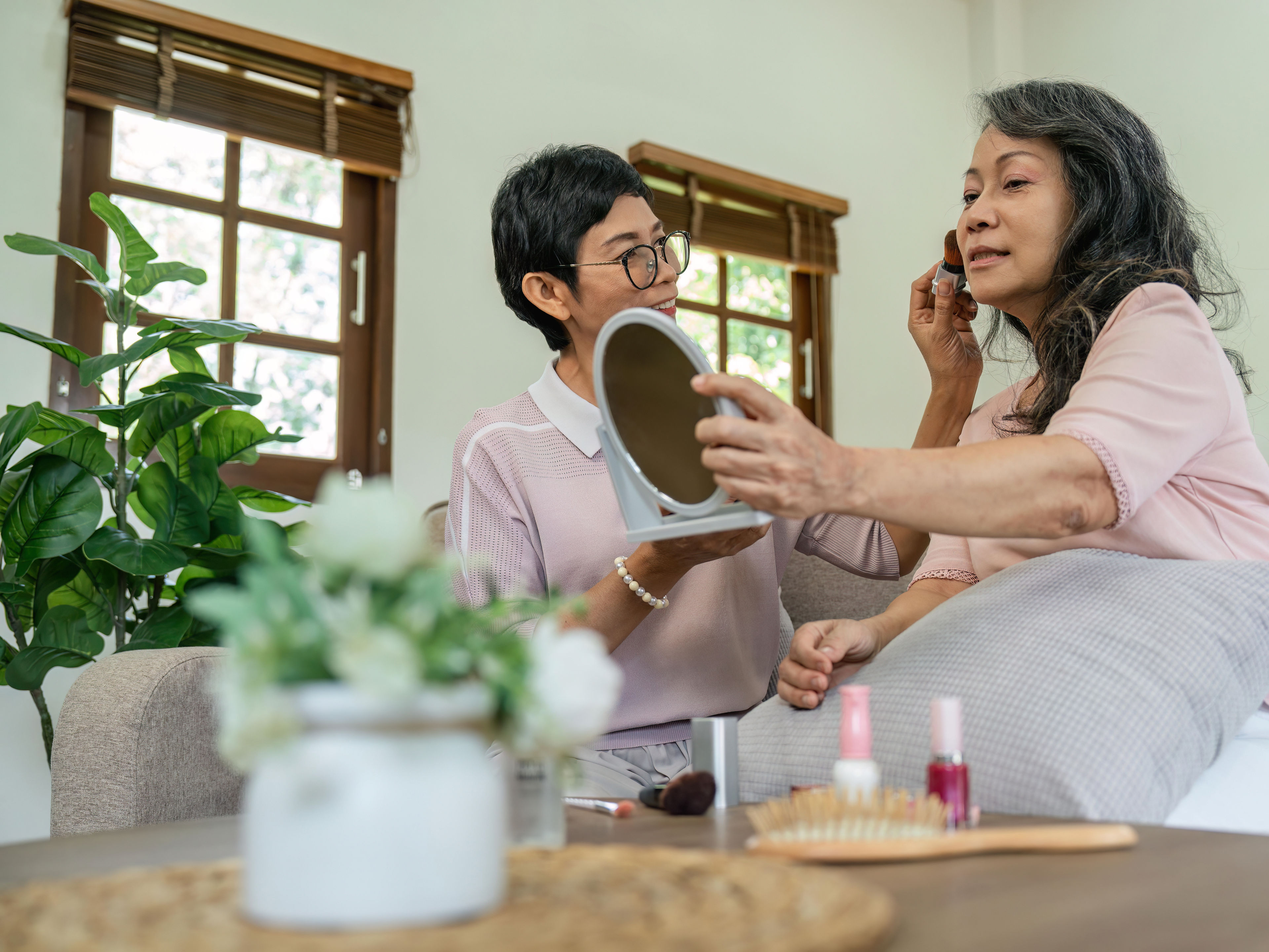 Two women doing makeup 