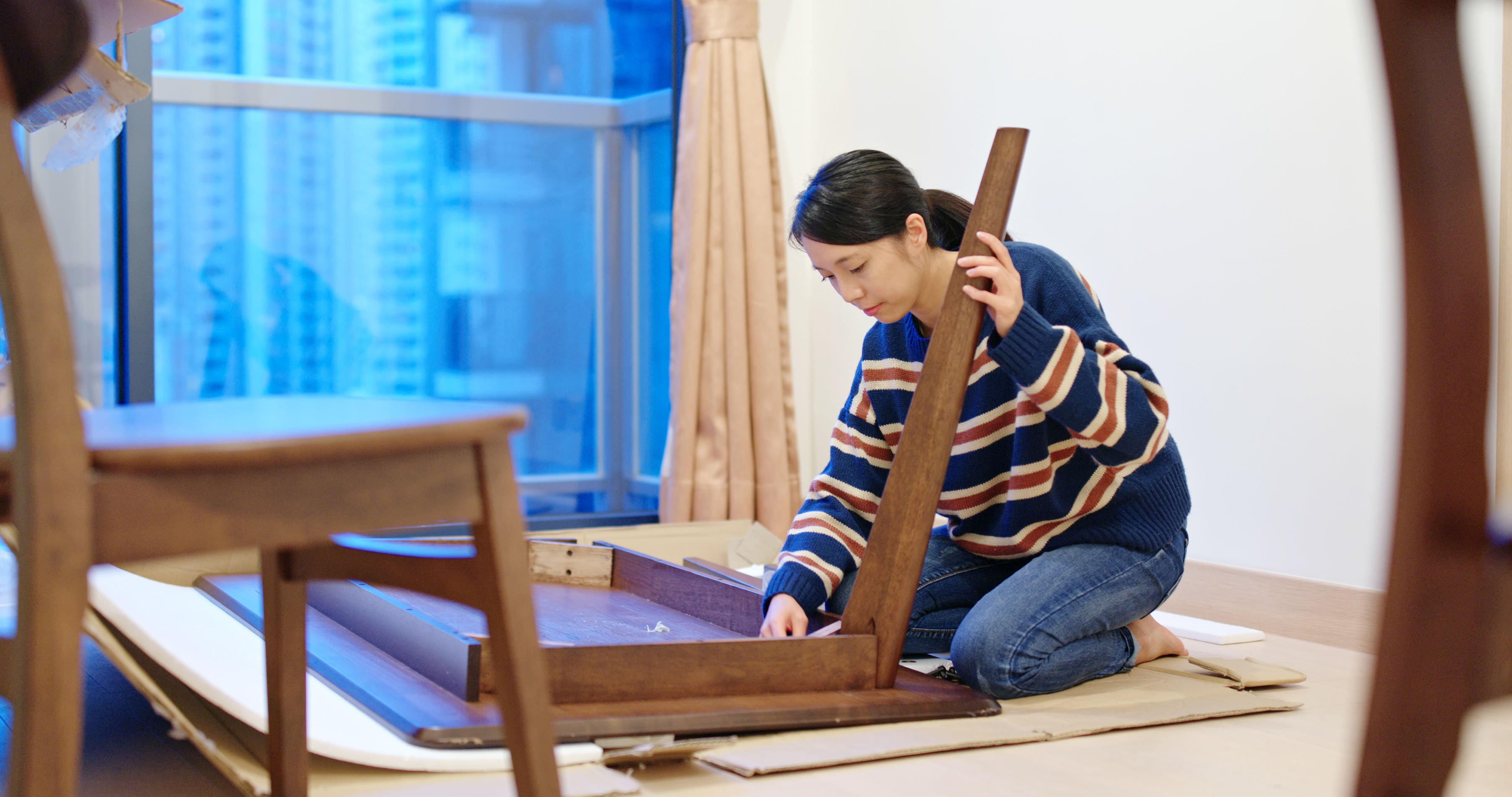 Woman assemble table at home 