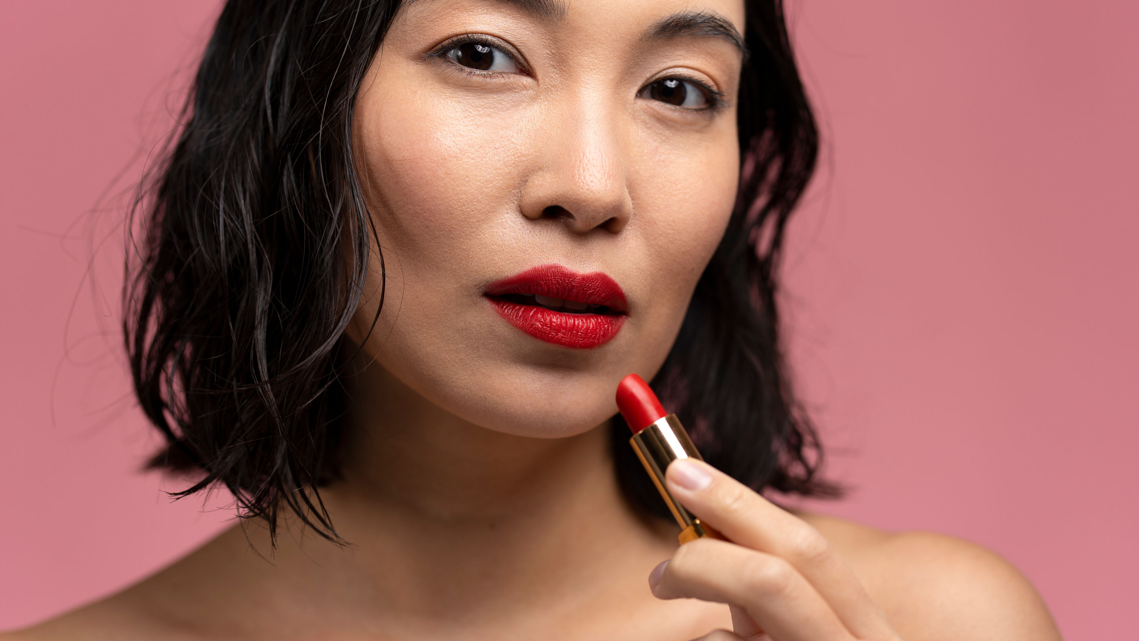 Woman using lipstick