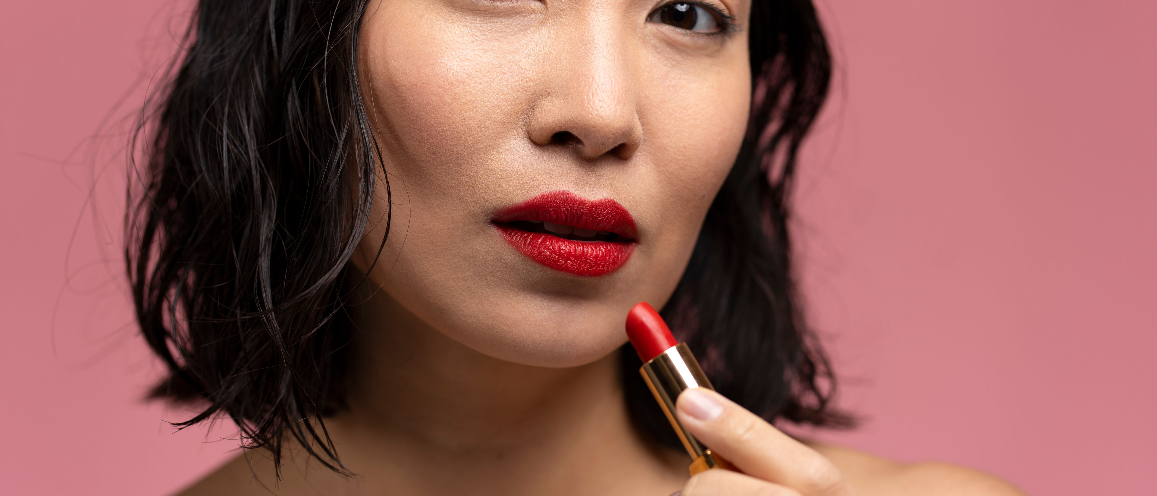 Woman using lipstick 