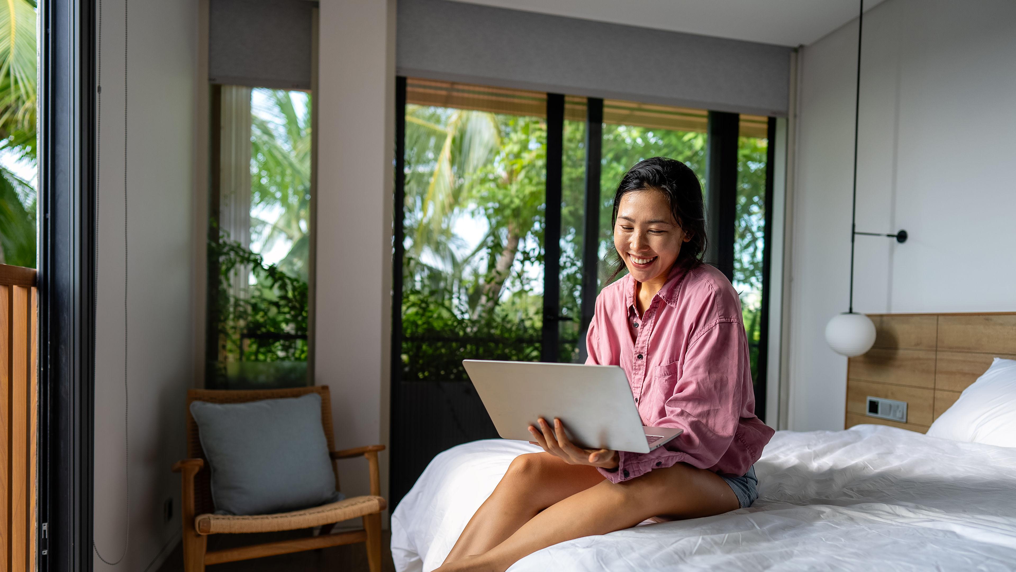 A traveller sitting on a hotel bed