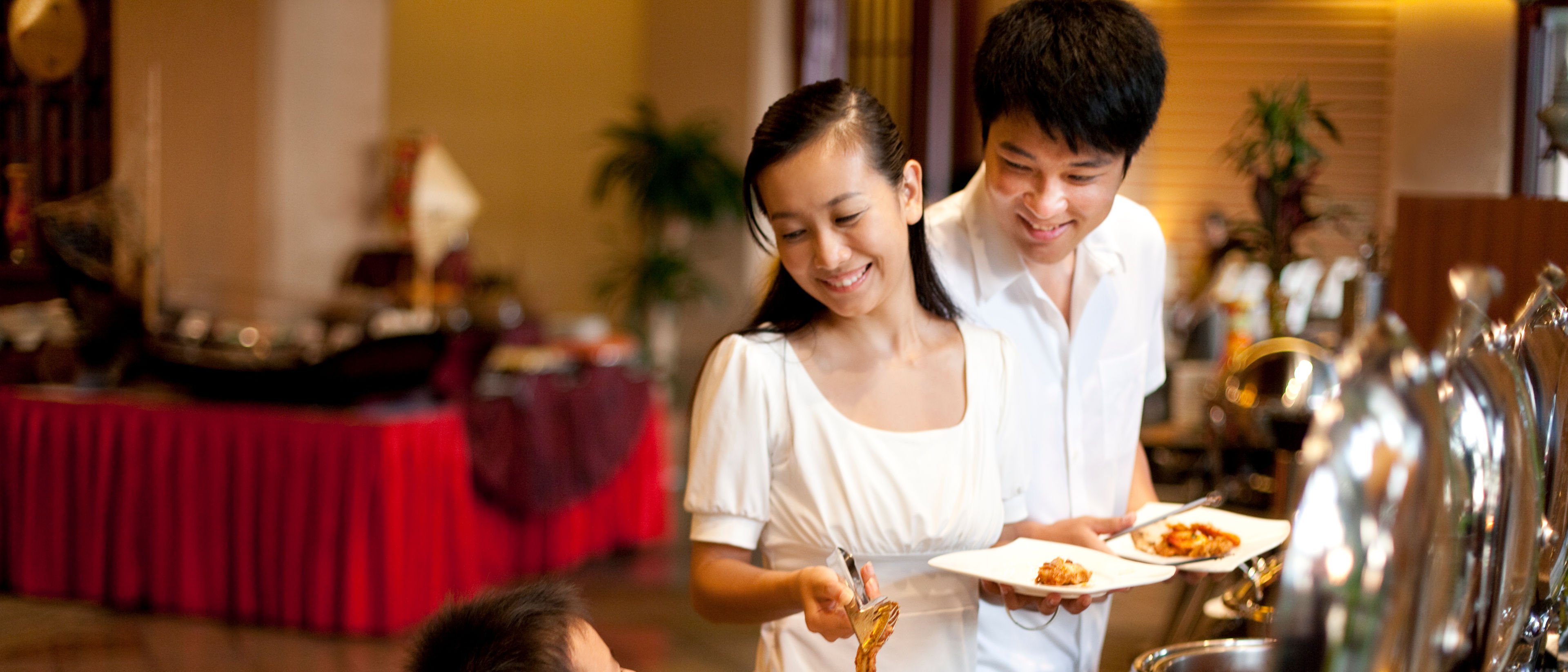A family of three having buffet in a restaurant