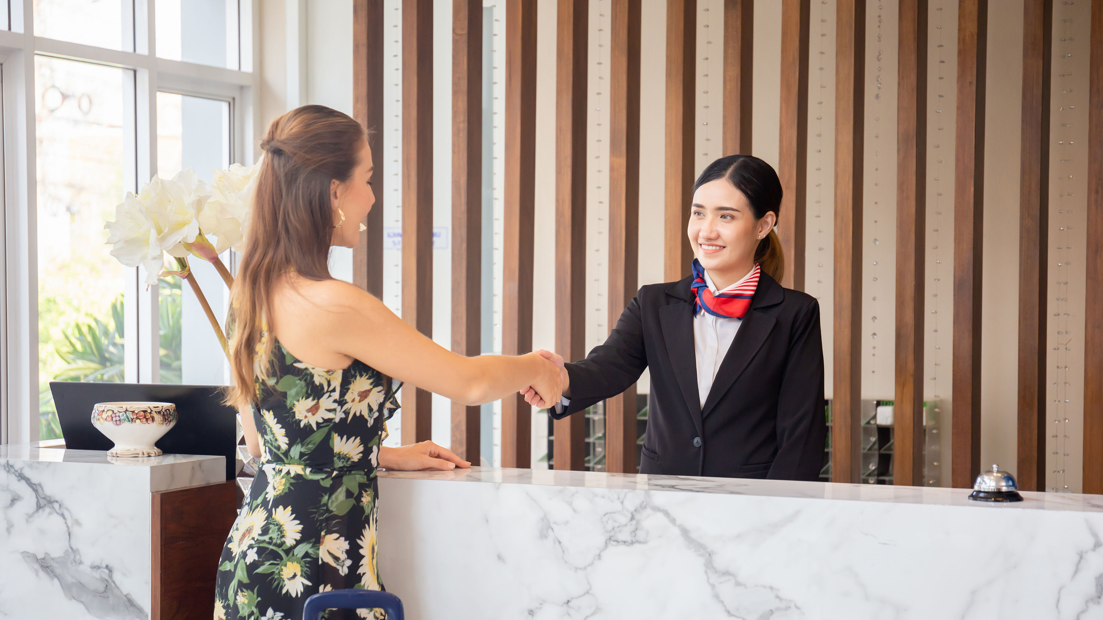 Receptionist And Guest Making Handshake 

 