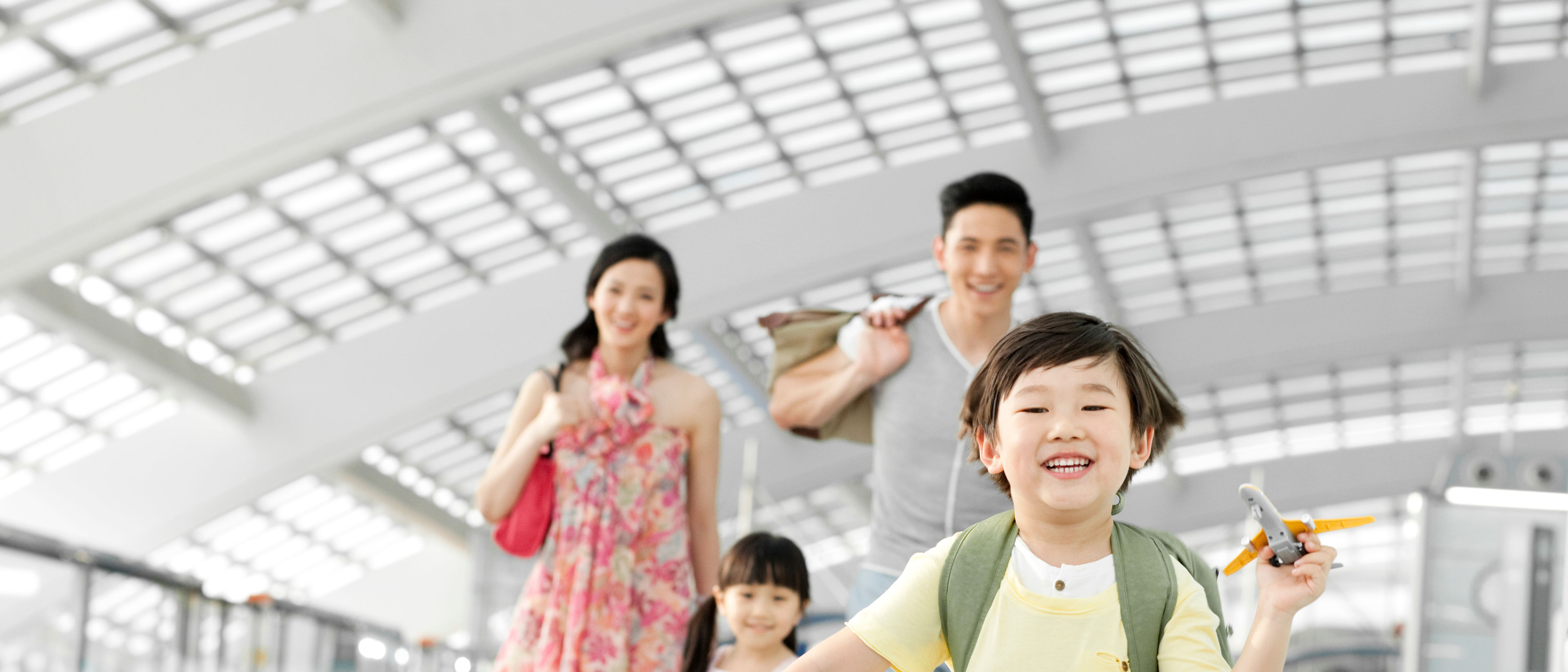 A family in an airport with travel essentials