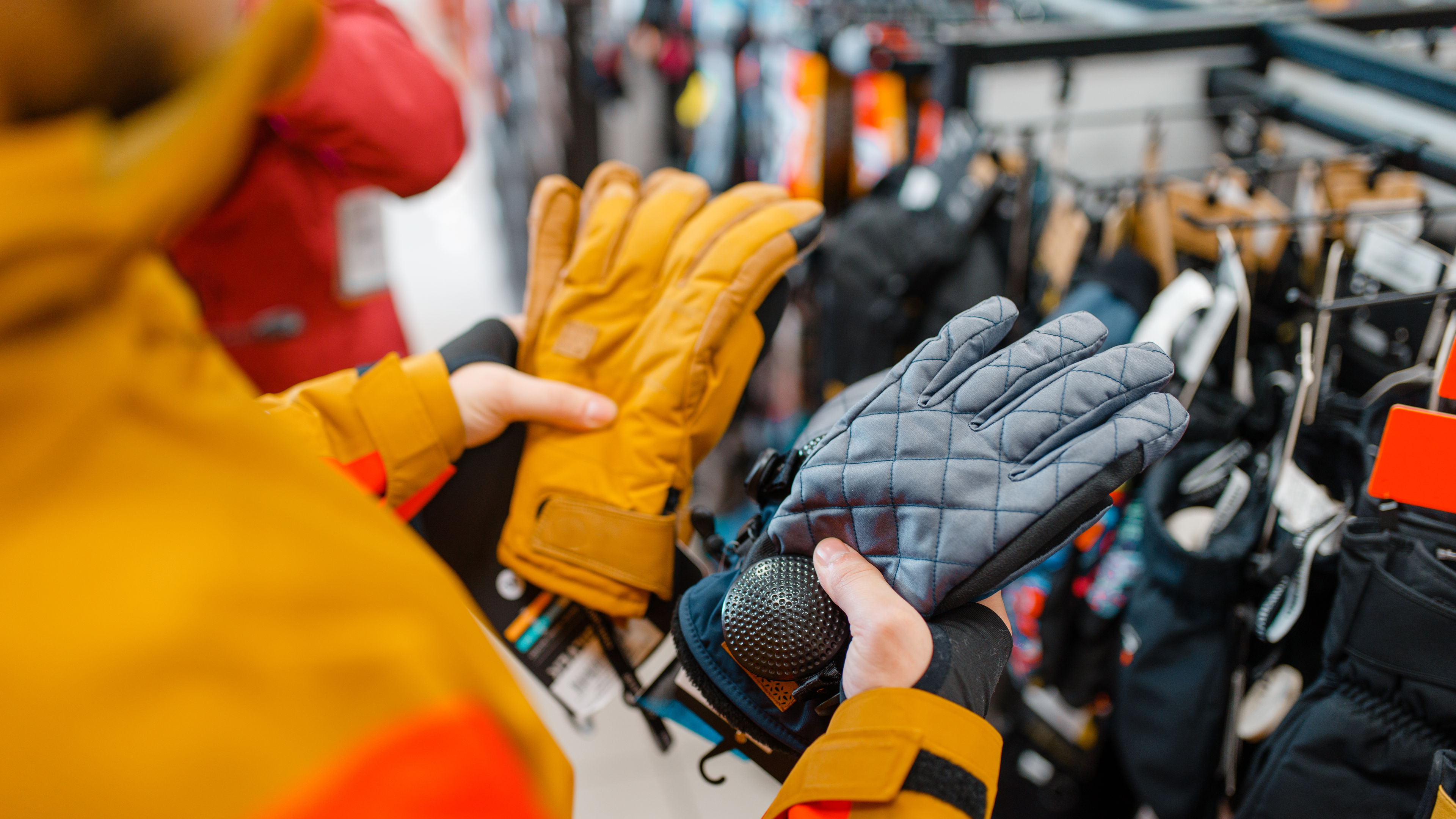 A person is shopping for gloves in a store