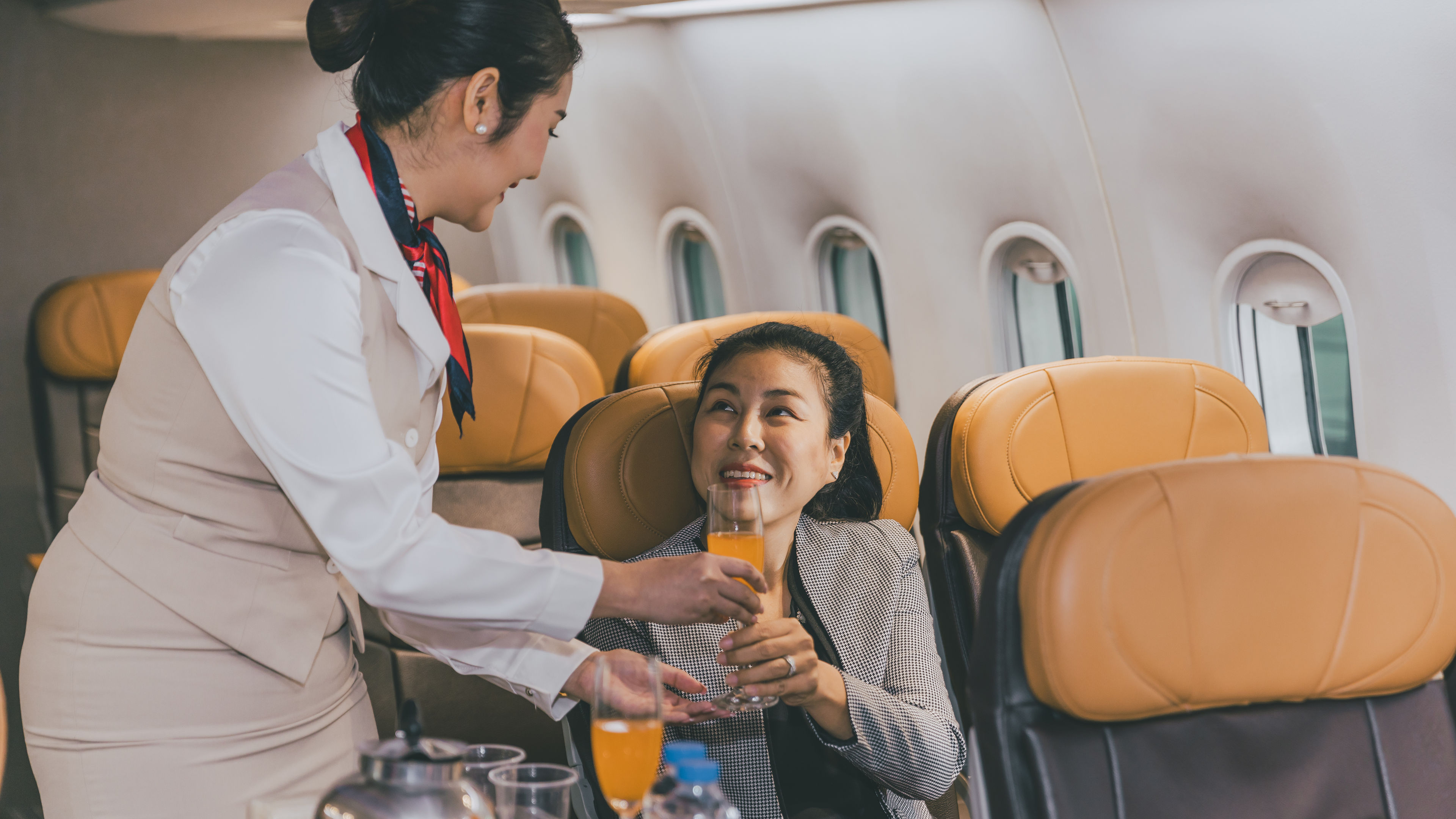 Air hostess flight cabin crew serve food and drink service passenger during travel on board