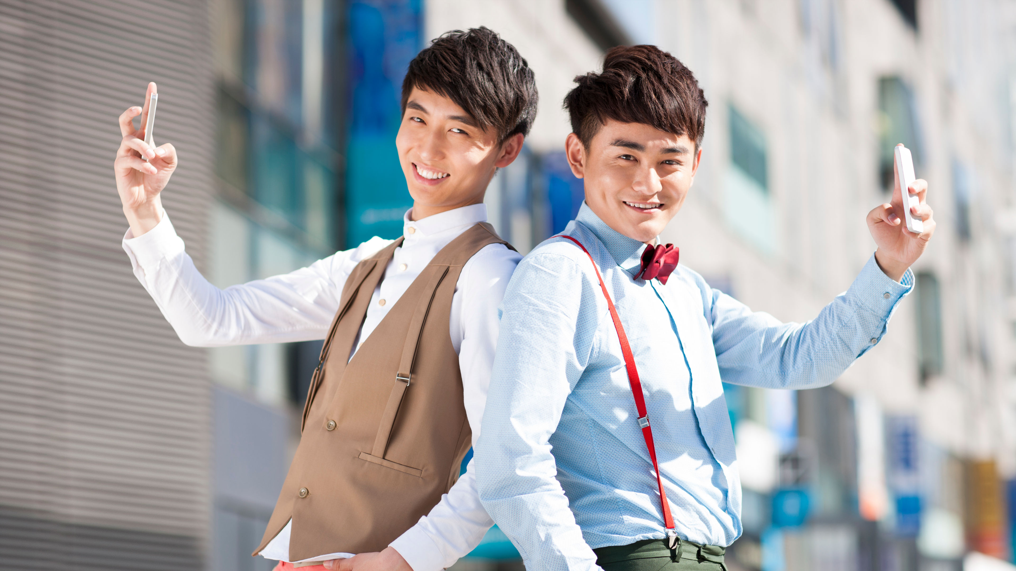 Stylish young men with mobile phones