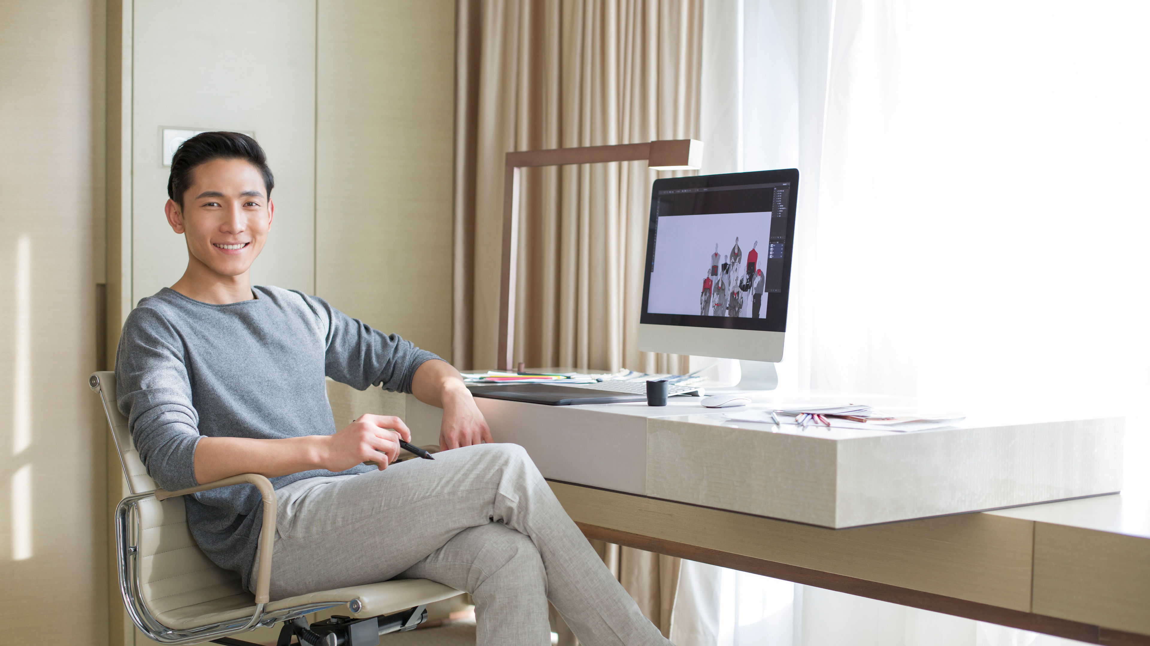 Young male fashion designer working at home 