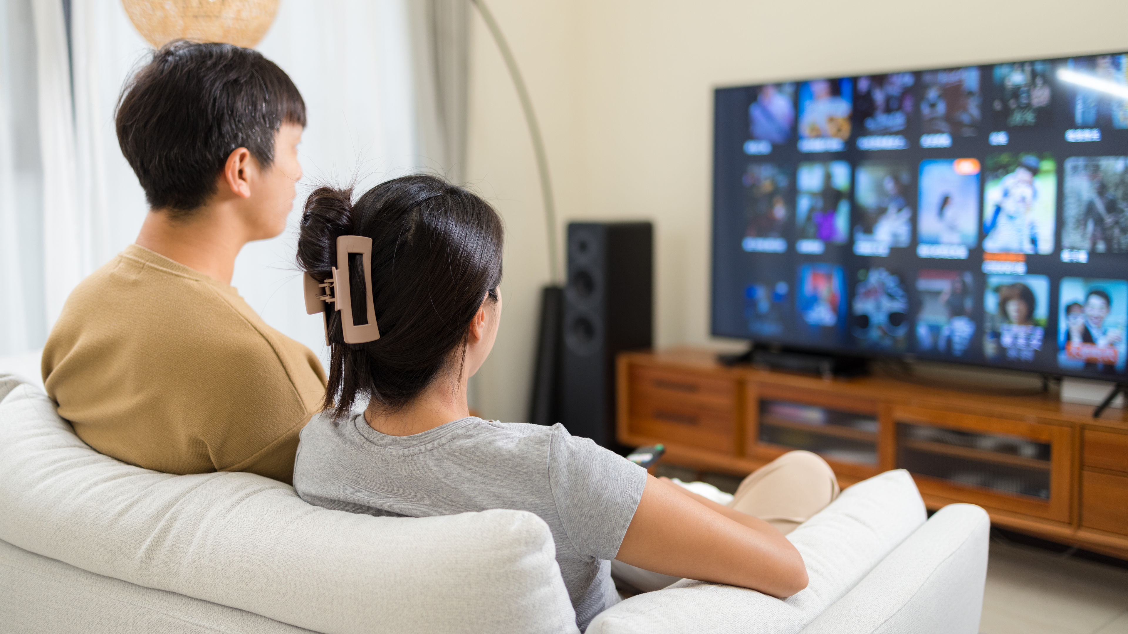 A couple watch TV at home