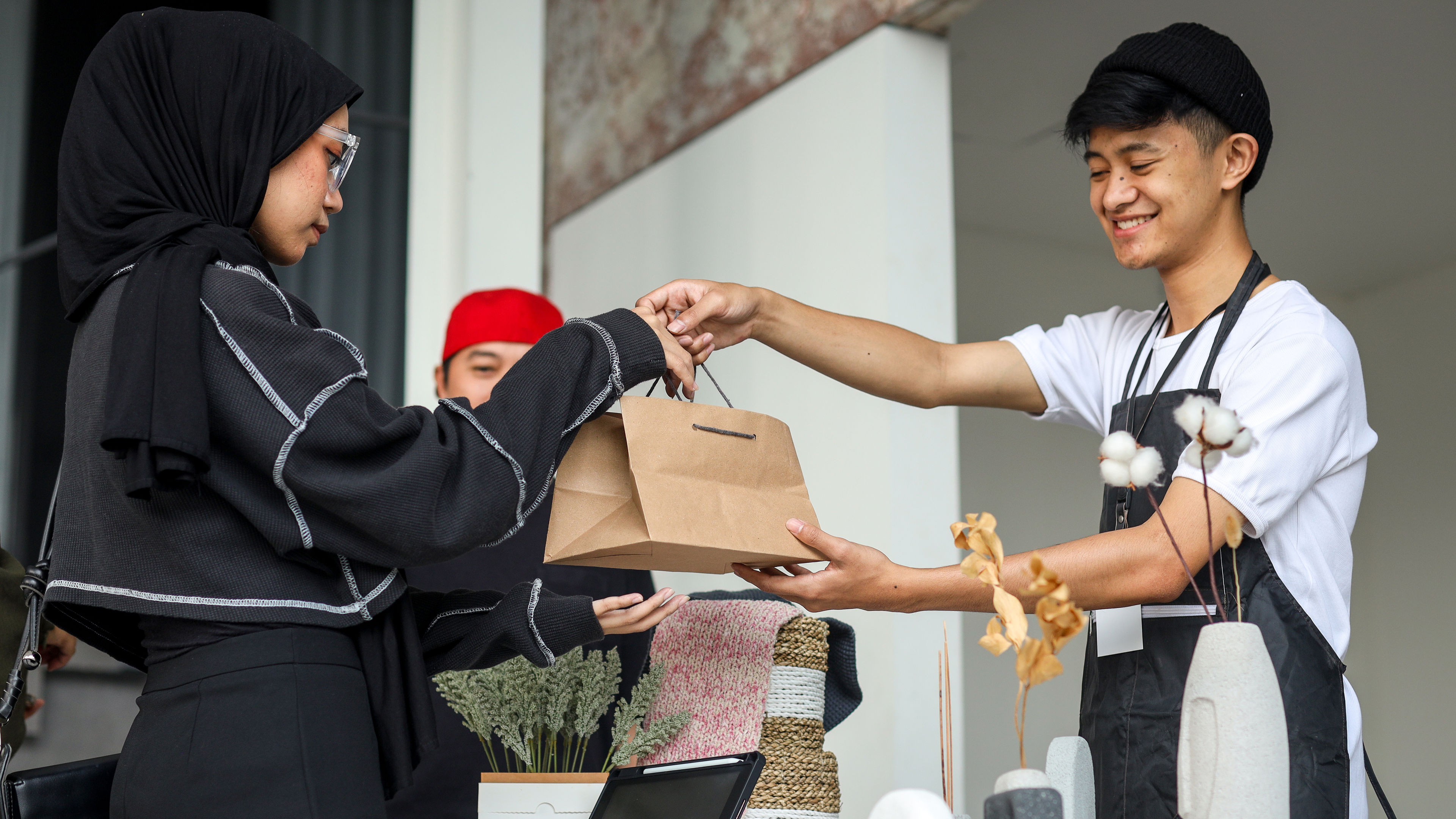 A happy young man delivering food 