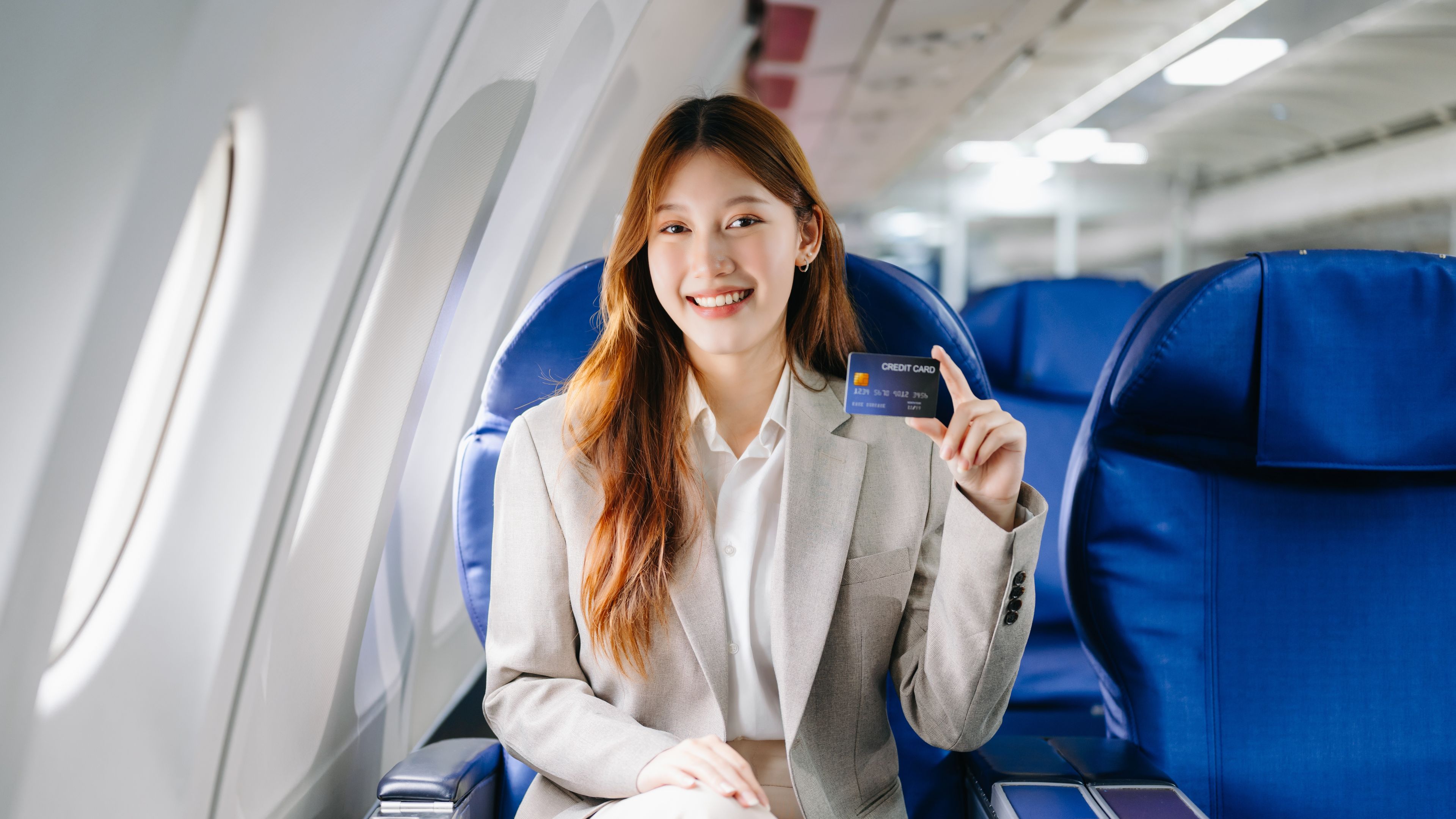 A woman holding a credit card