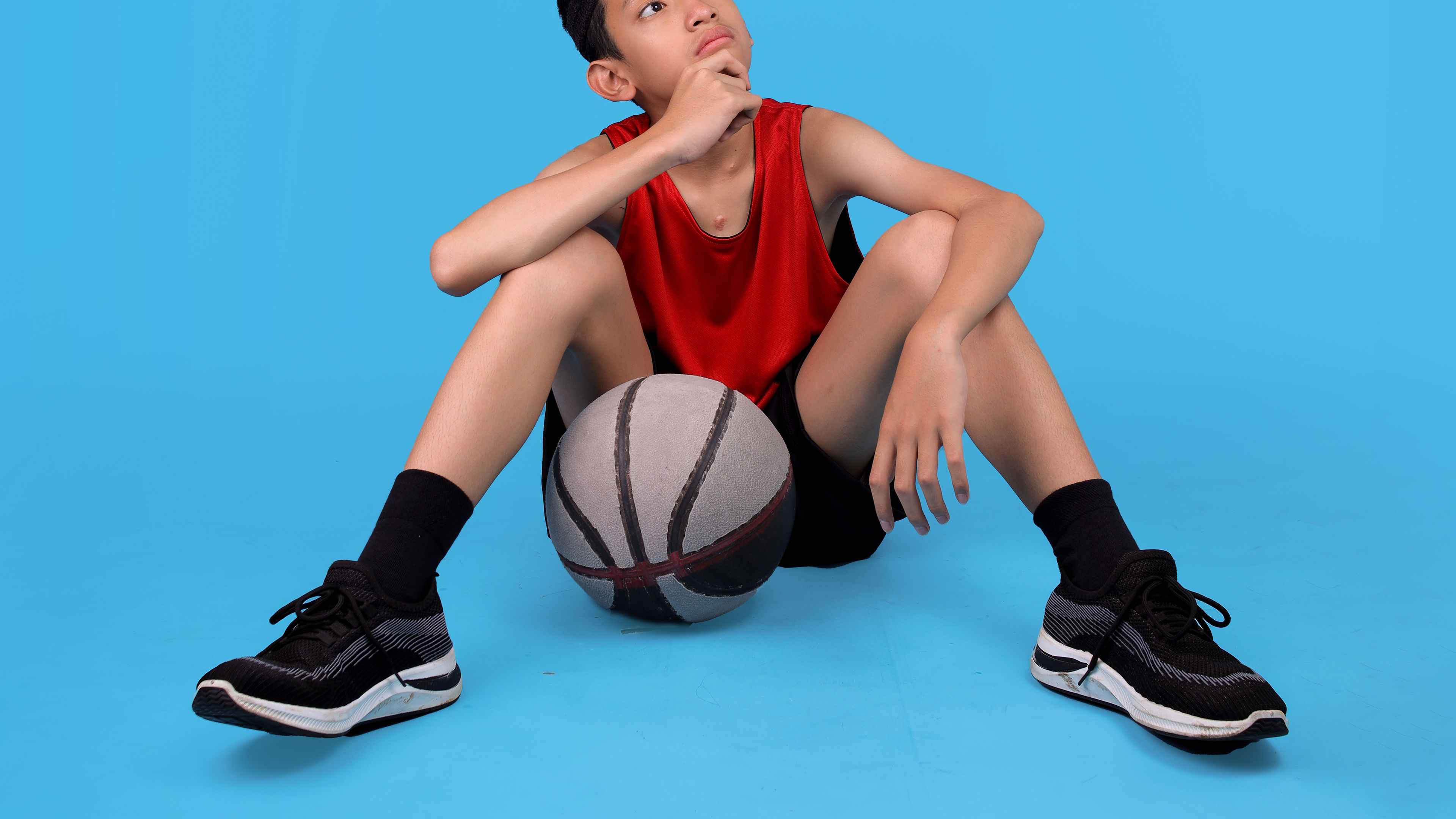 An Asian boy in sports apparel