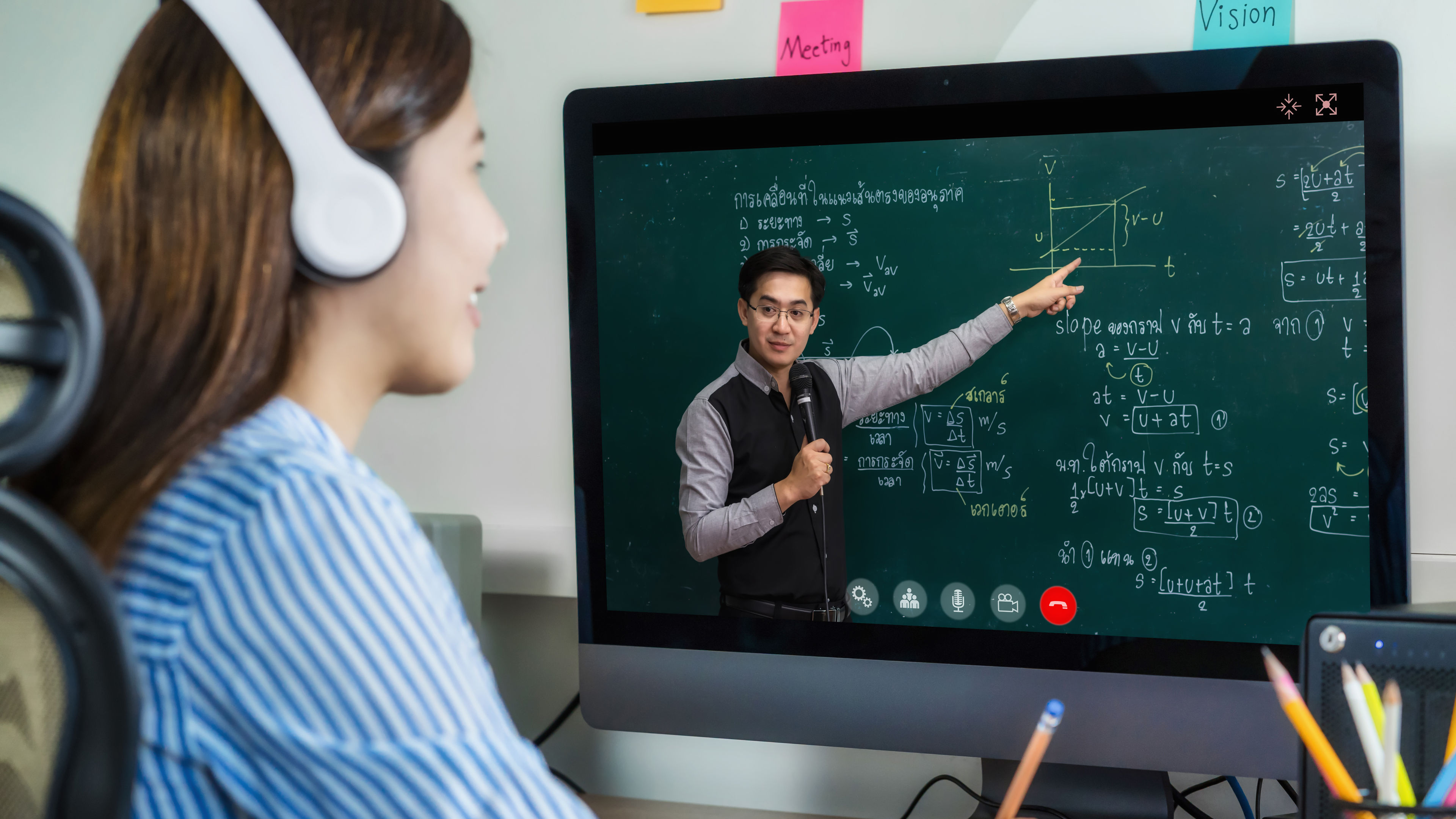 Asian student learning with teacher 