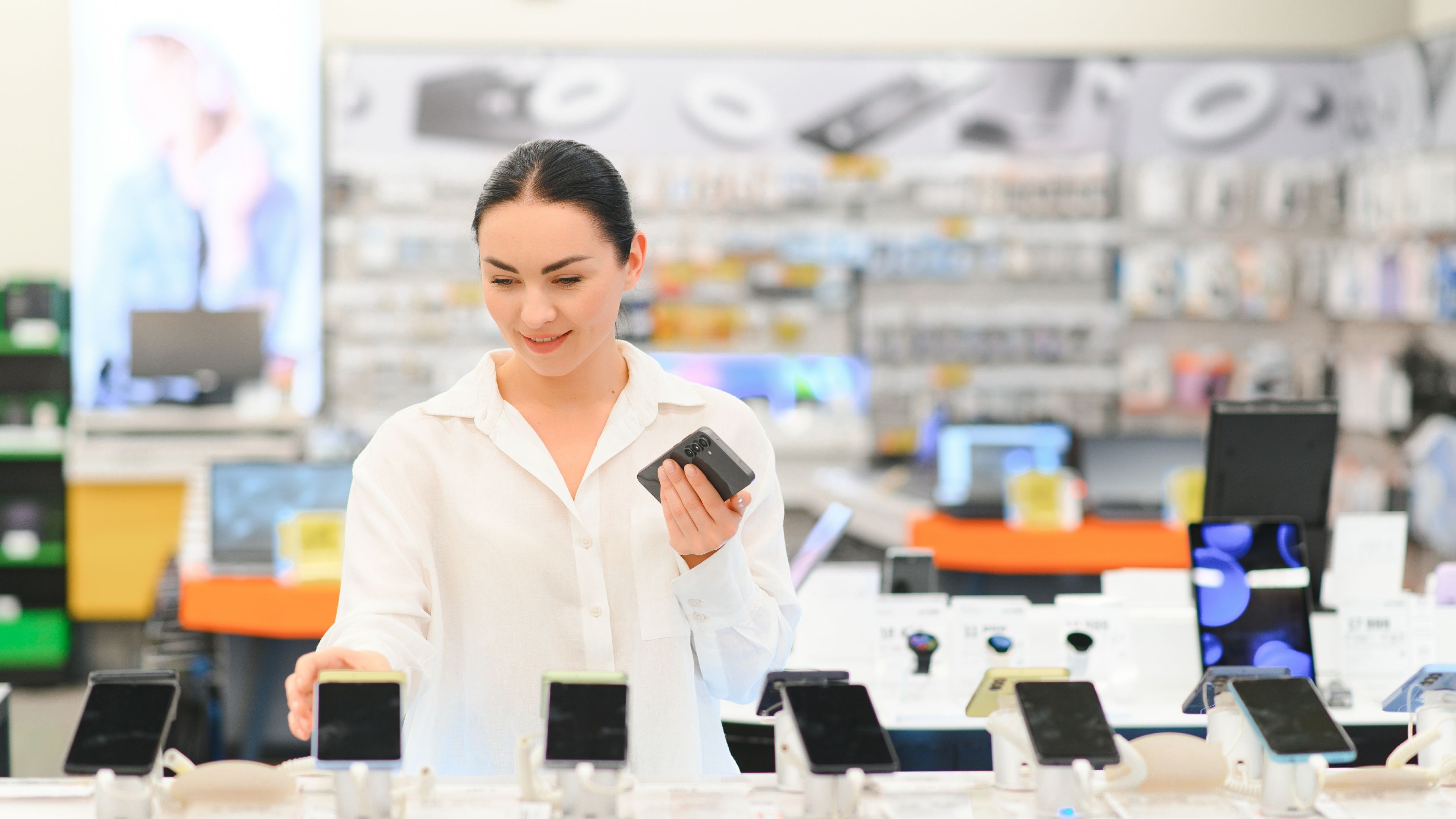 Buying a new smartphone at a tech store. Looking for a new piece of tech gadget 