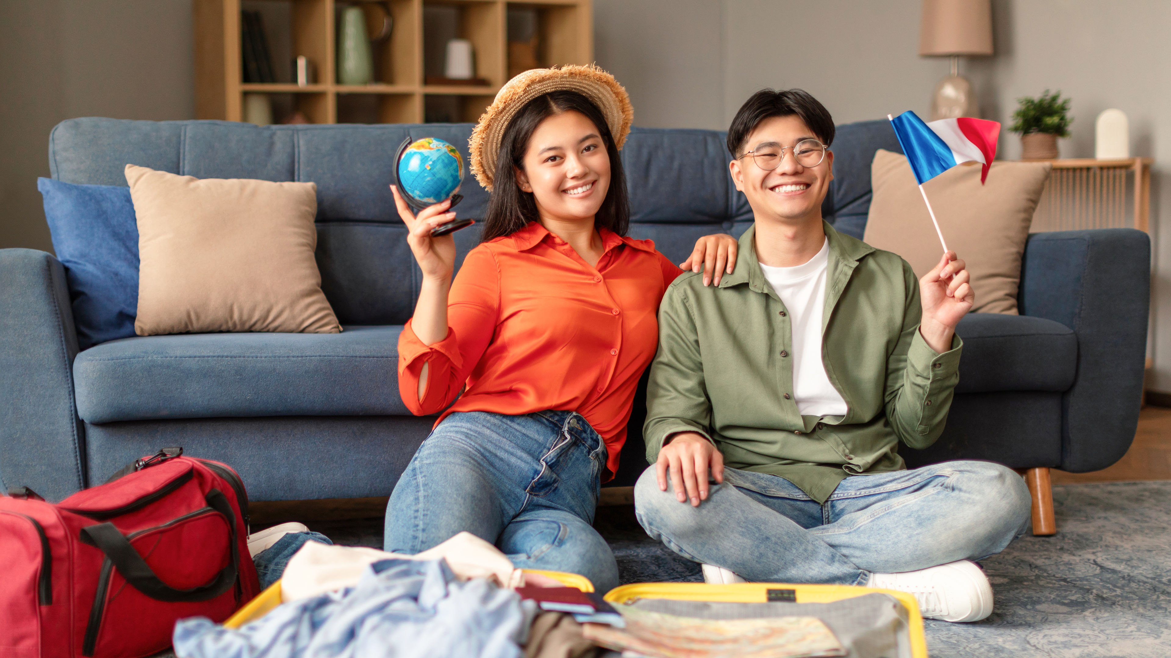 Couple sitting infront of travel bag