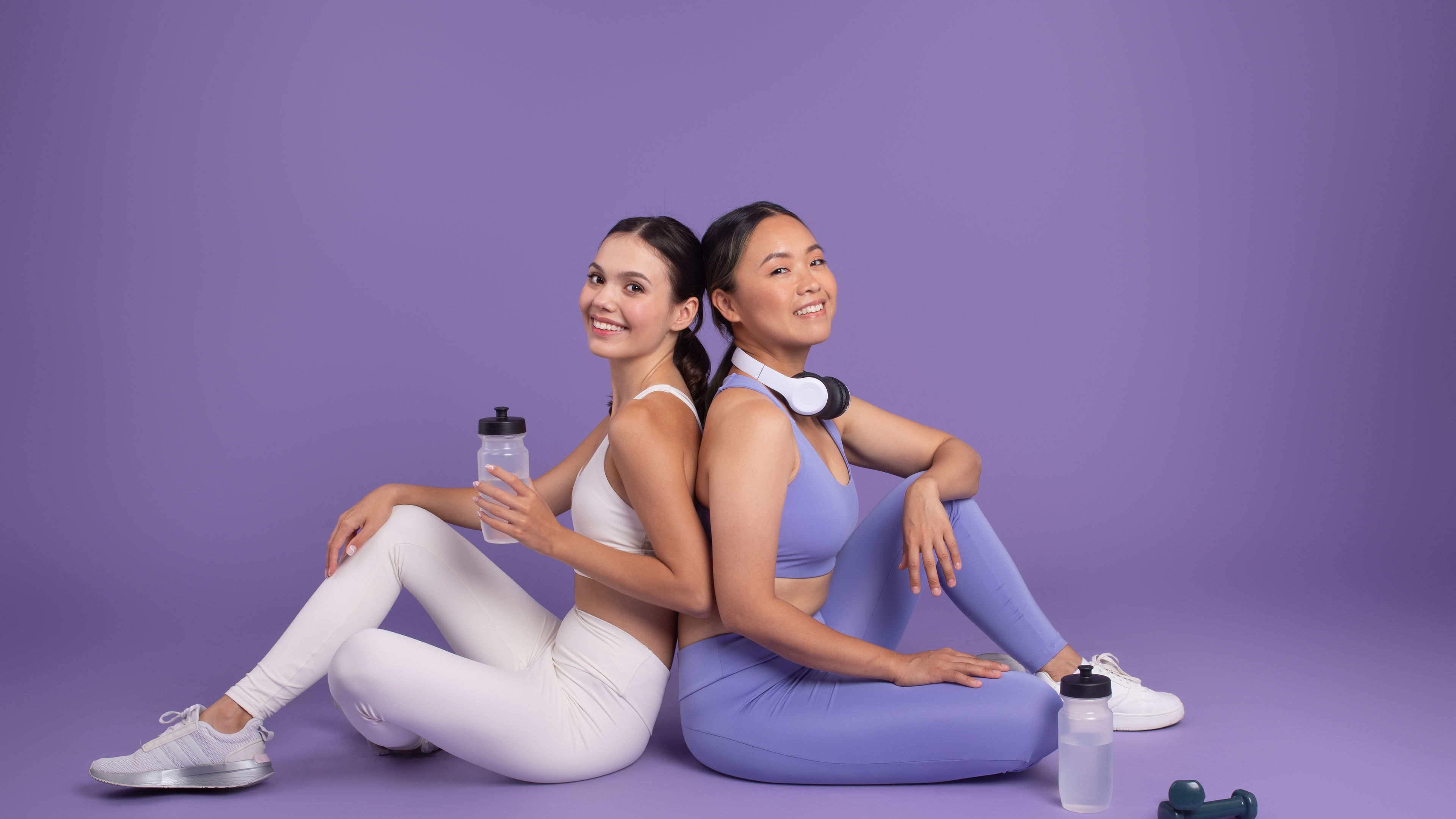 Diverse ladies in sportswear sit and rest