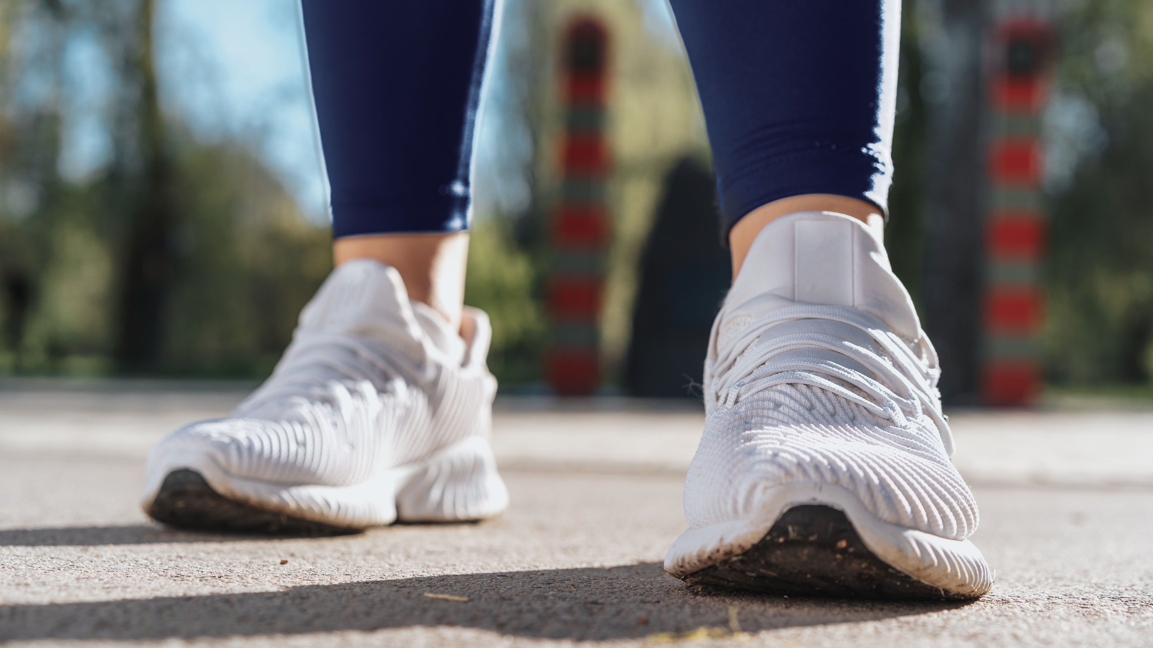 Feet of a woman dressed in sportswear and sneakers for running,