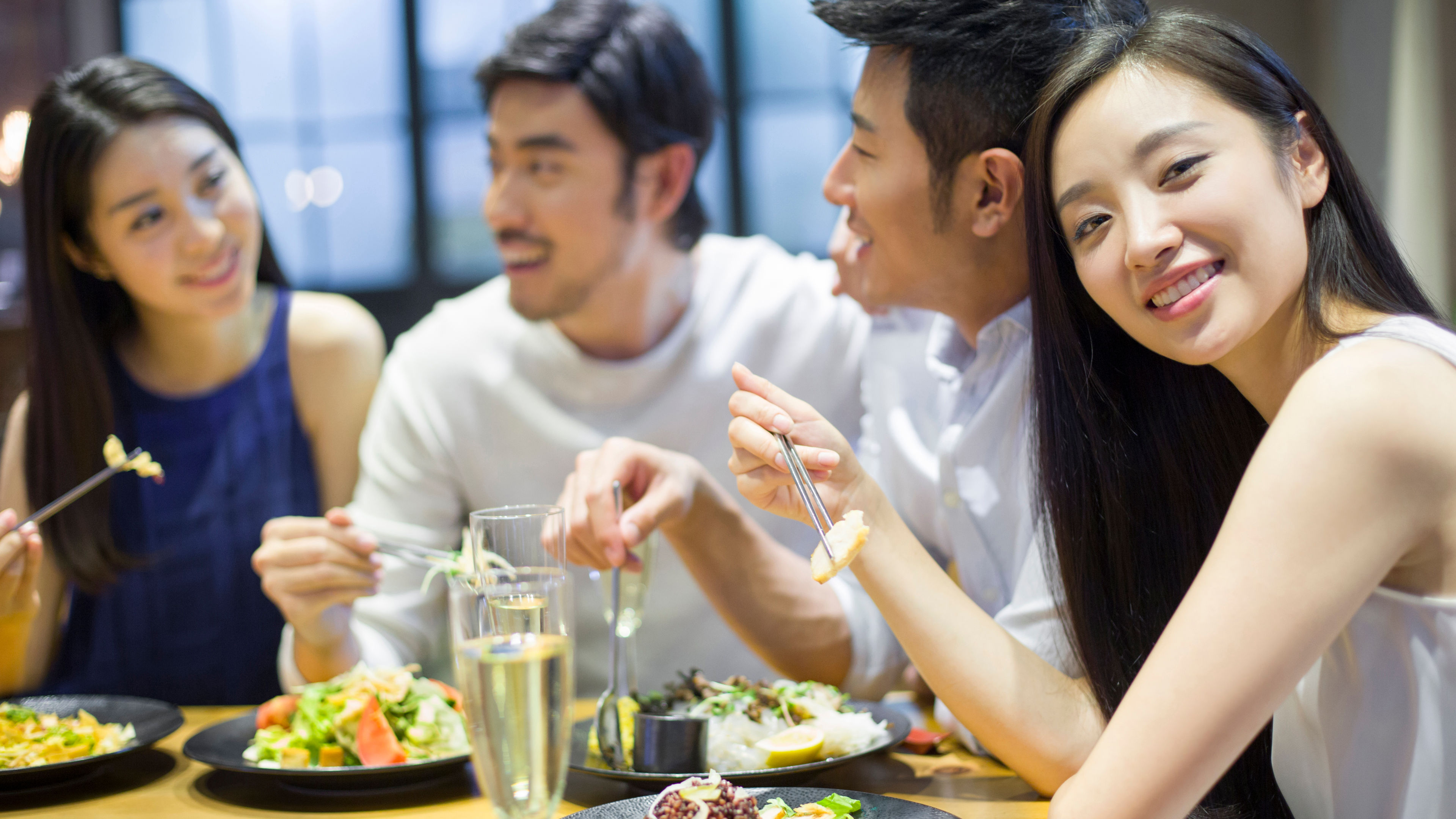 Group friends enjoying food outside and a female girl posing