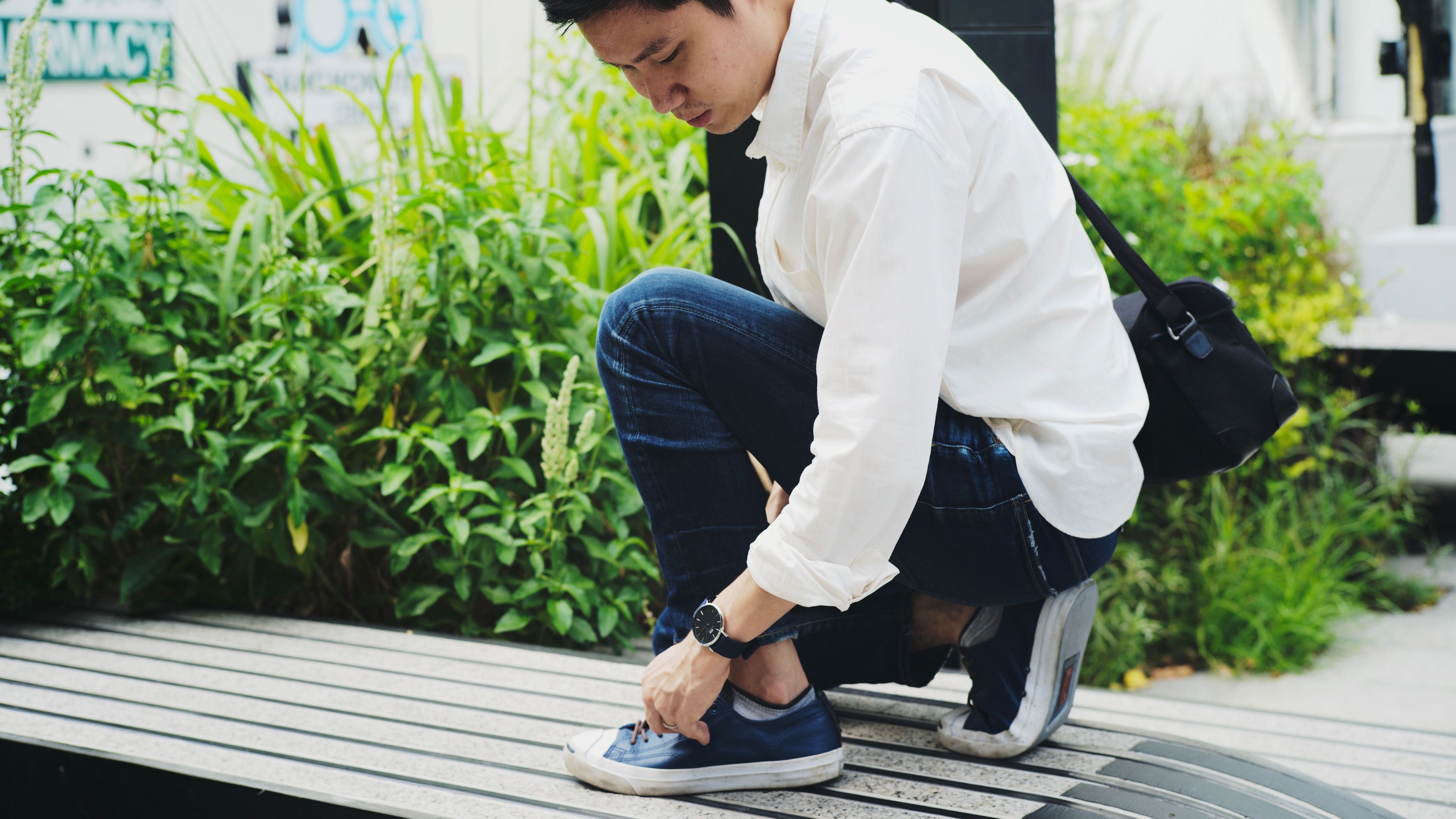Man touching the footwear.