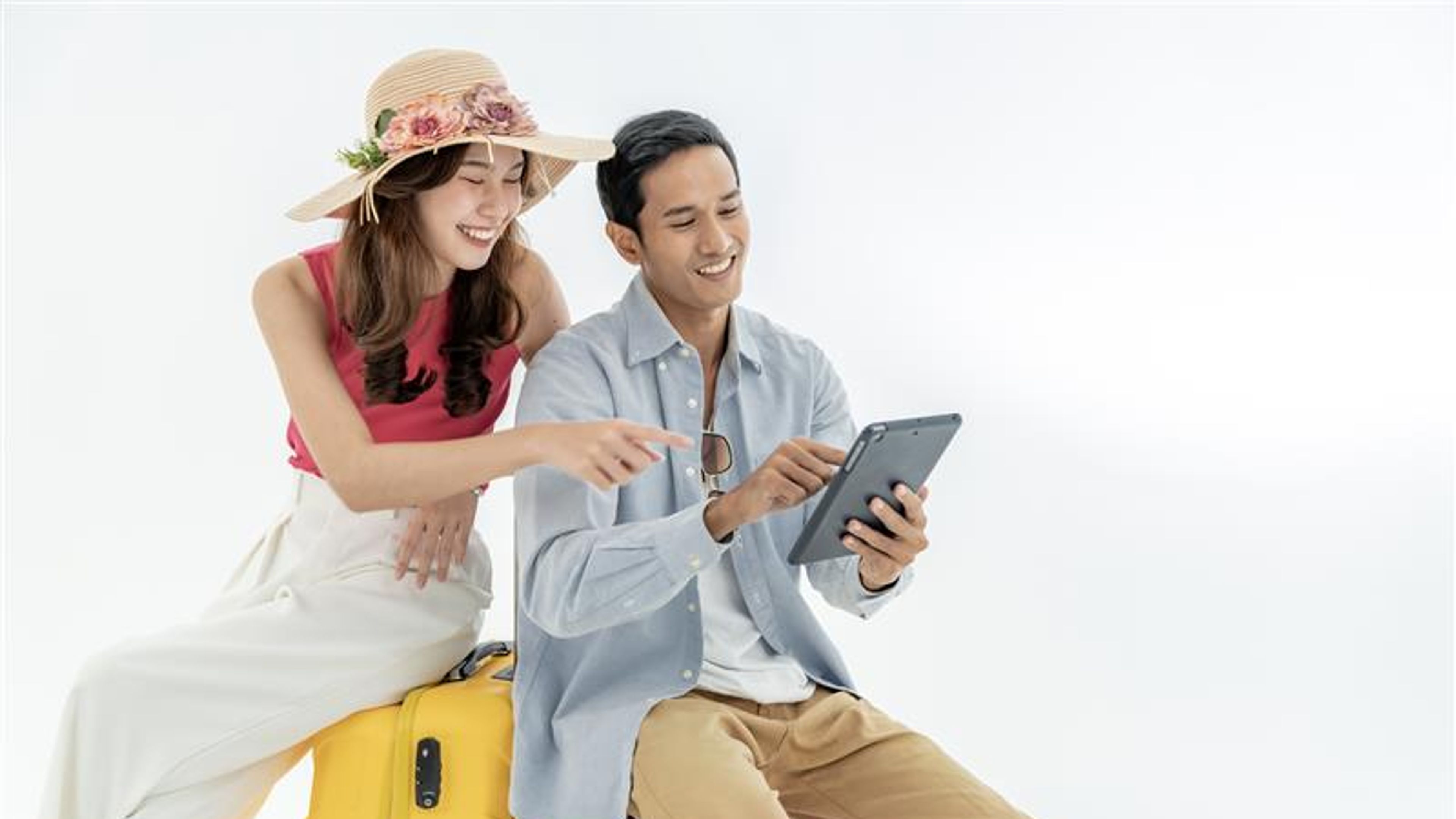 Portrait of an Asian couple with their suitcases, passports and travel tickets. 