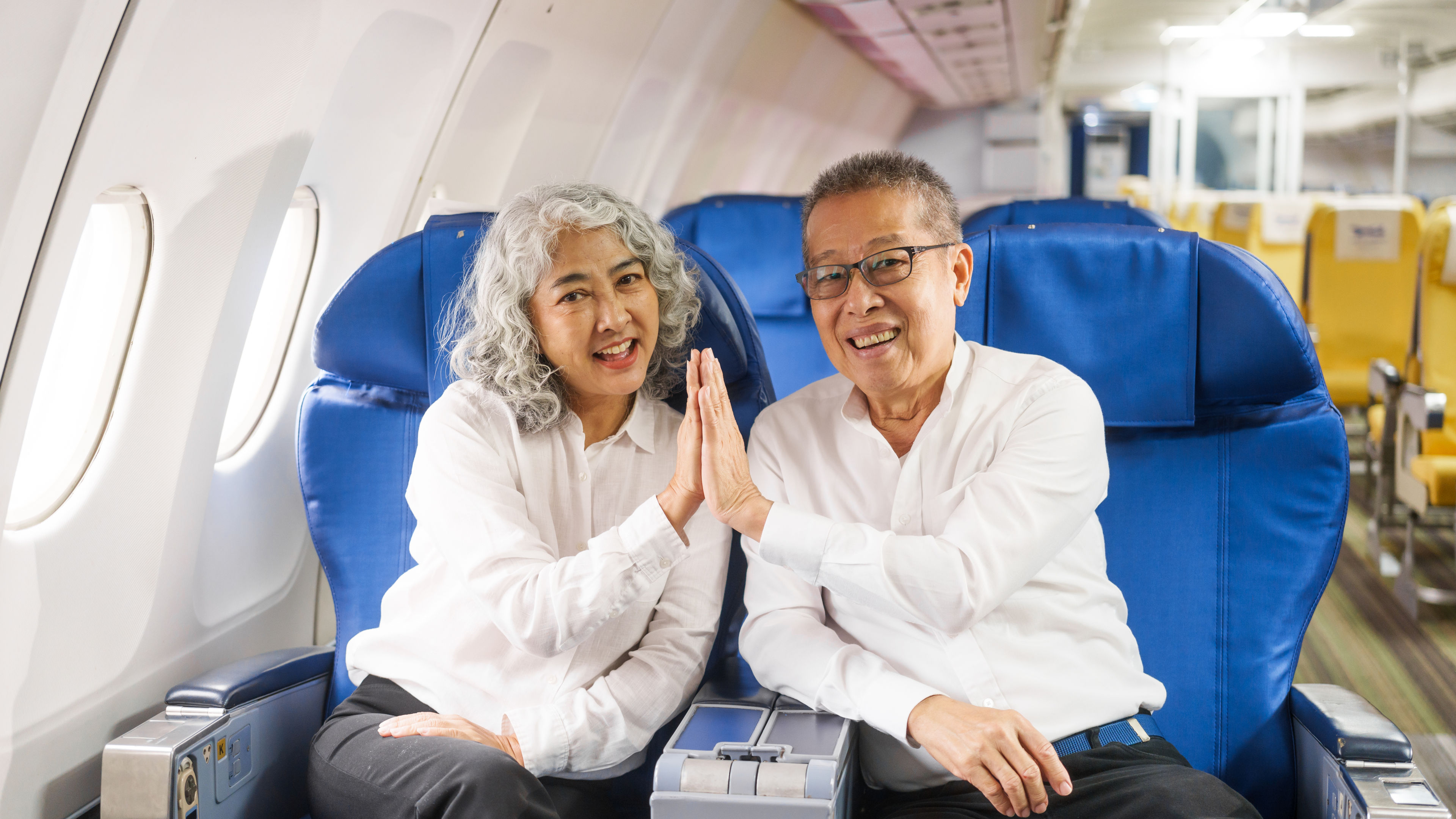 Senior Couple Travels Together on Airplane