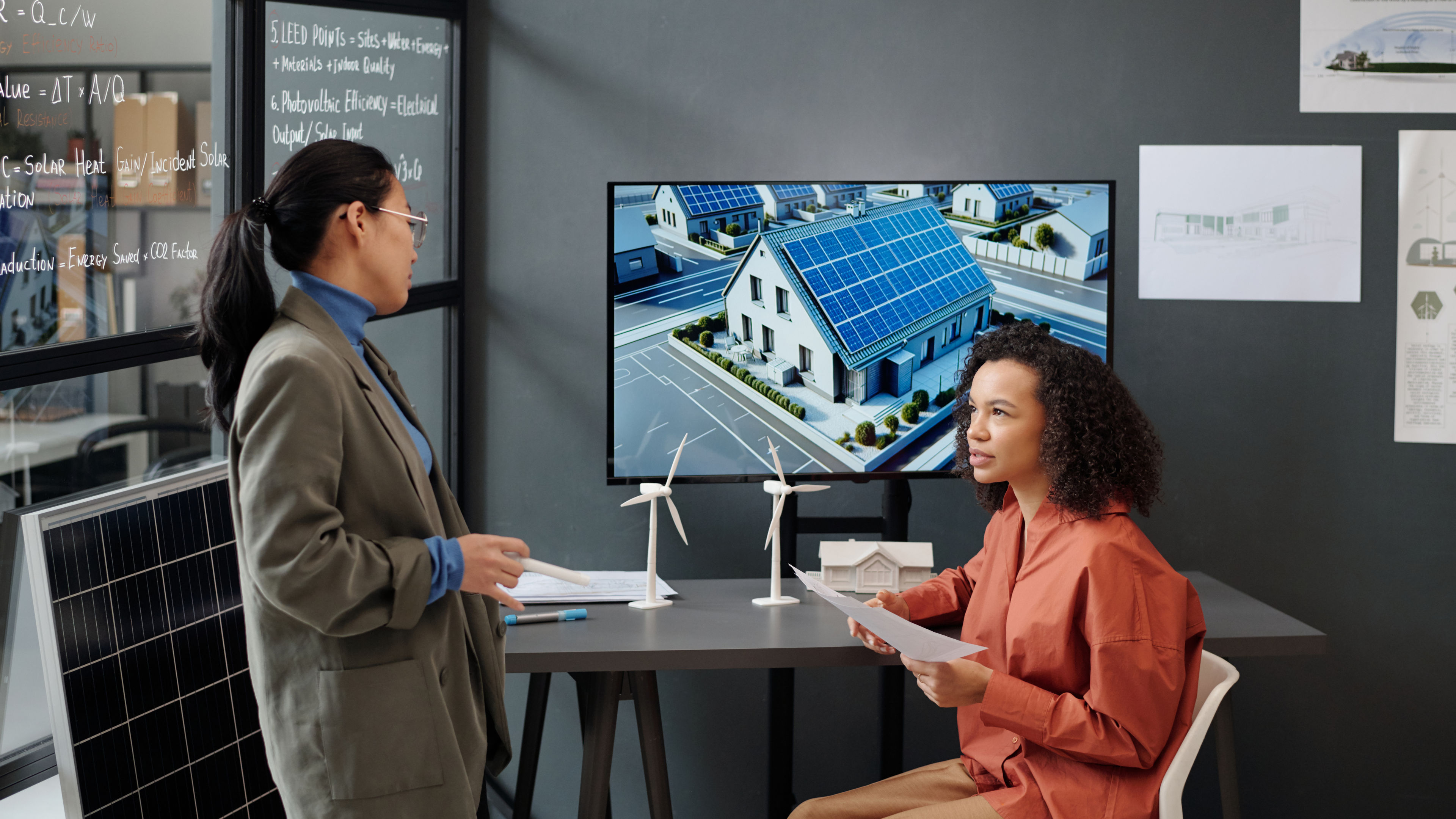 Two women preparing for presentation 