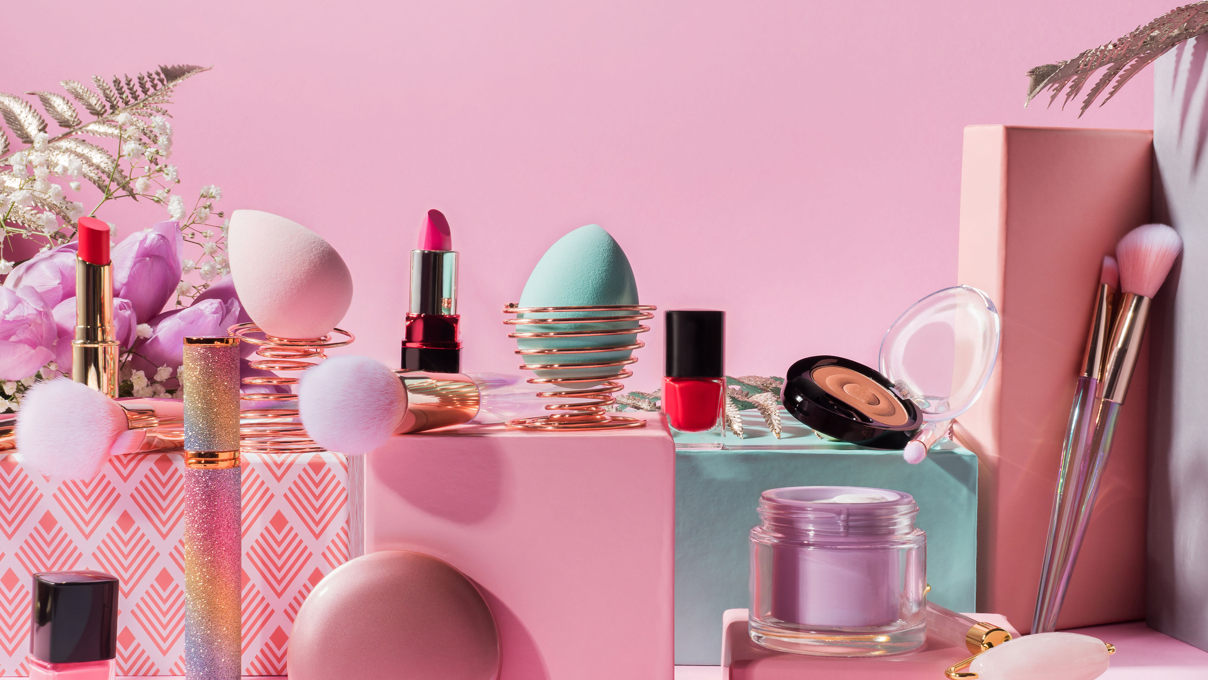 Different make-up products like creams, serums are displayed on a table 