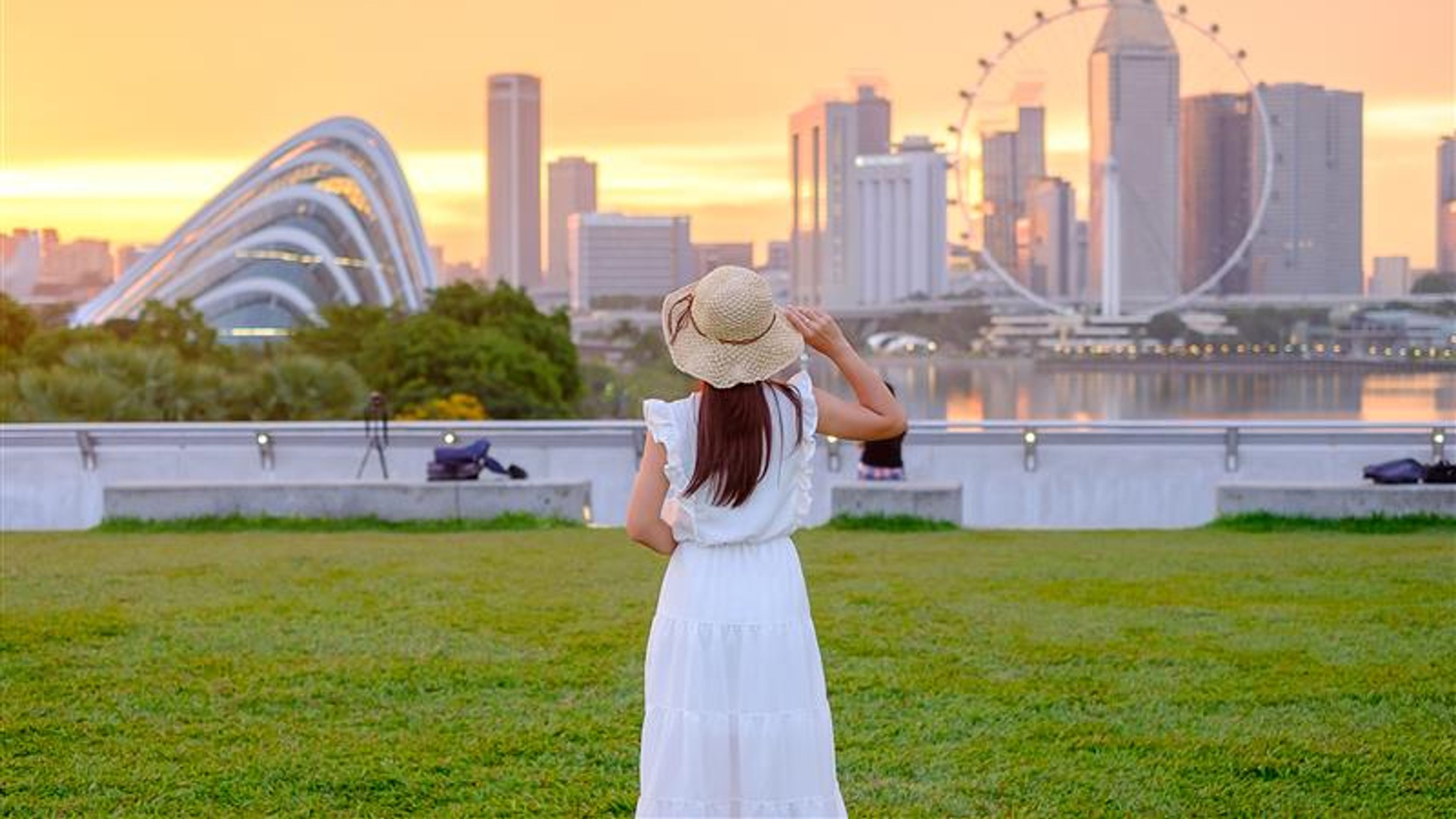 A woman exploring Singapore, admiring the city's skyline and vibrant streets. 