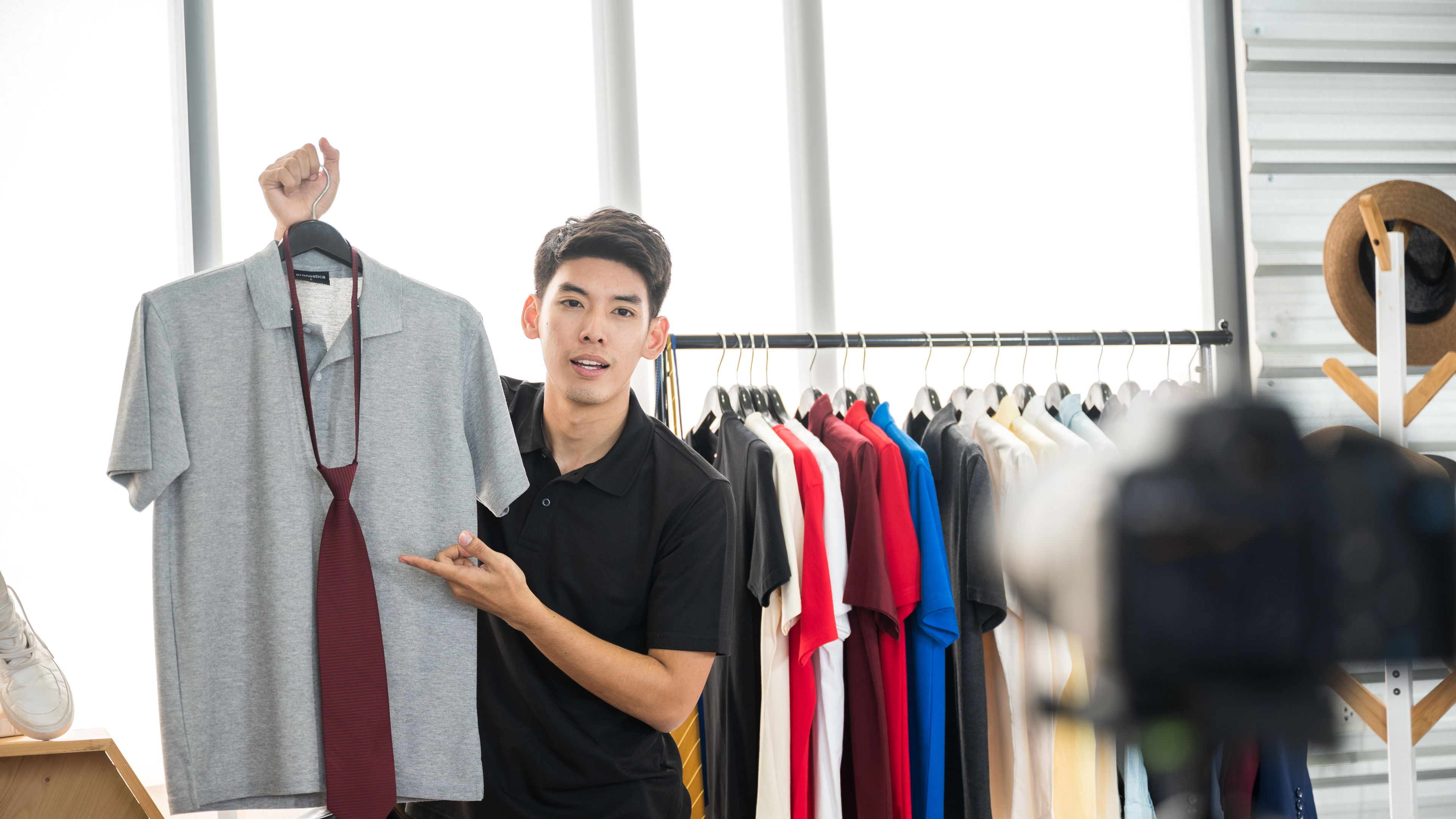 Young men recording video for selling shirts online