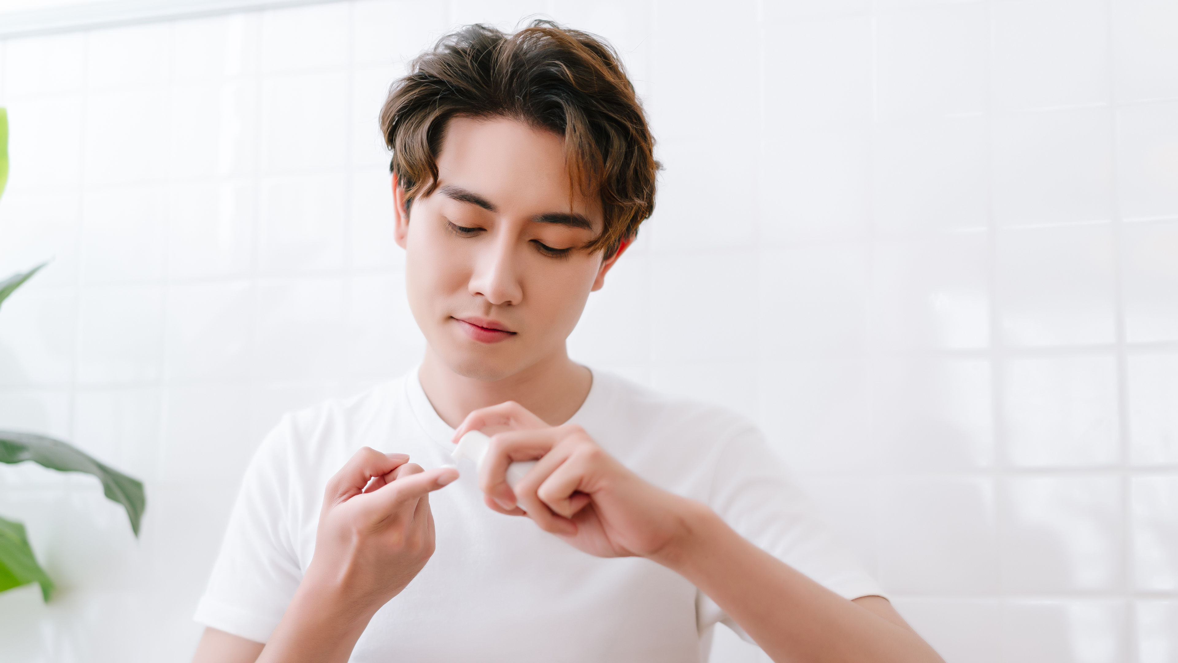 Man taking cream from bottle