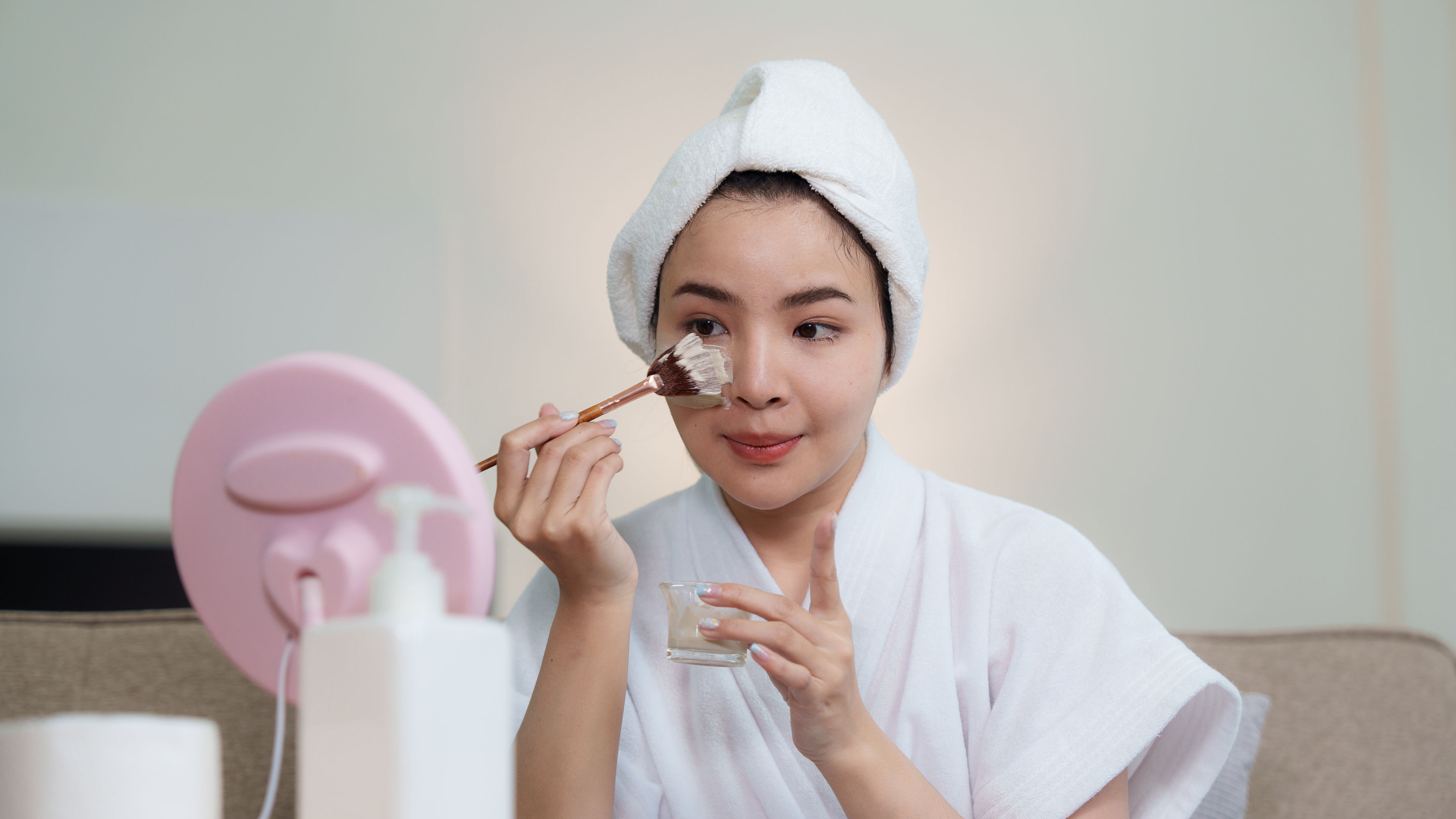 Woman applying face mask