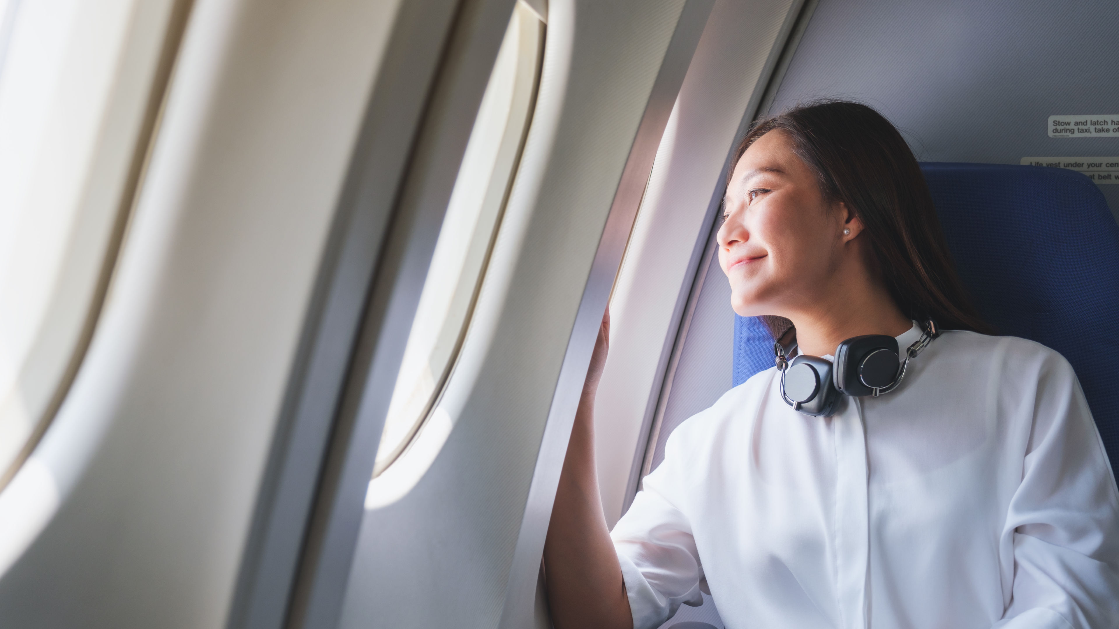 Woman in Airplane Looking out of Window