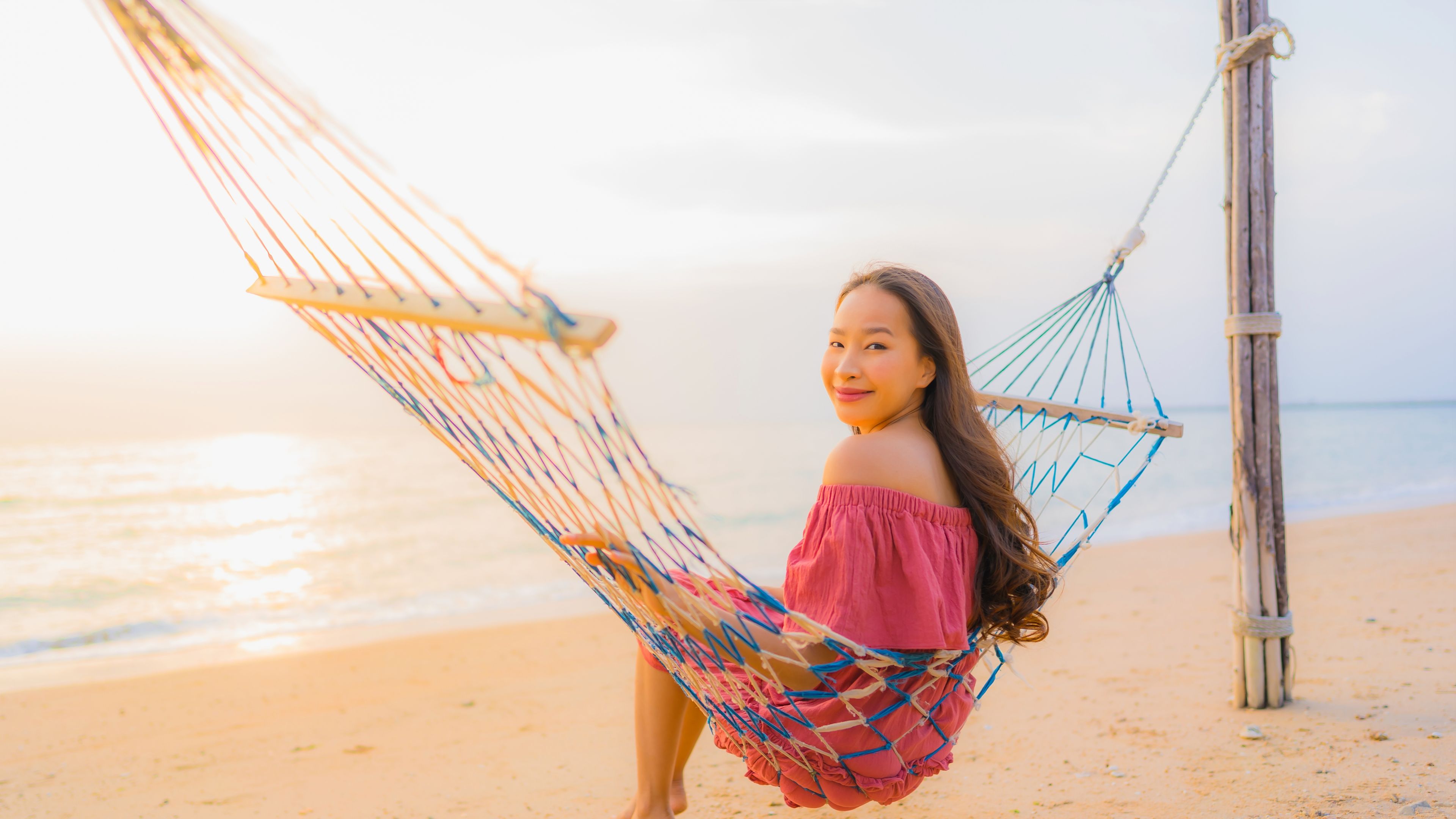 Woman sitting on a hammock