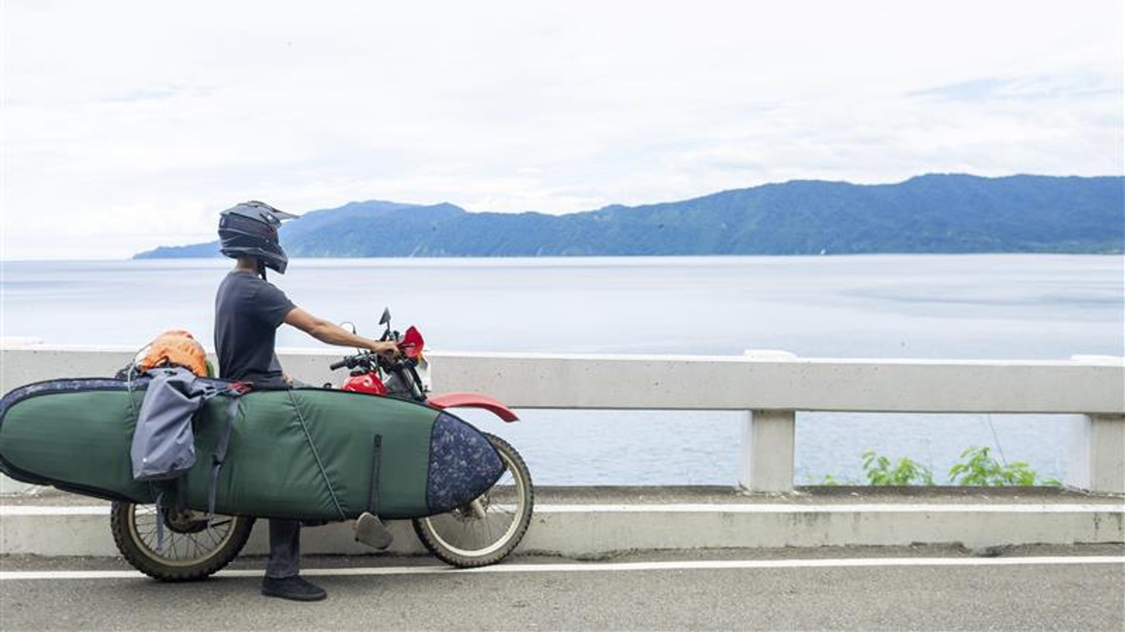 A man taking a rest in a bike near a water resource