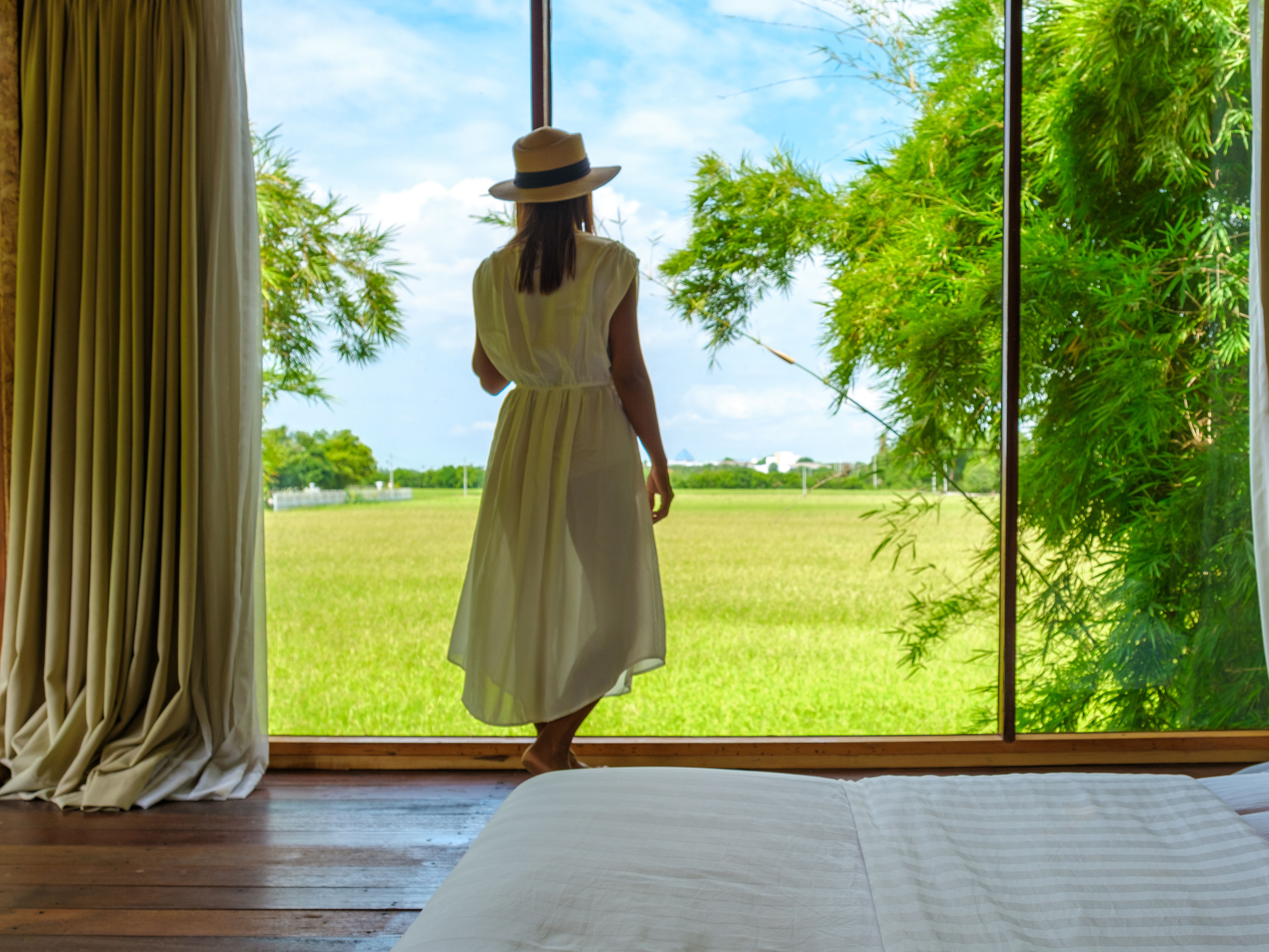 Asian women standing by the window
