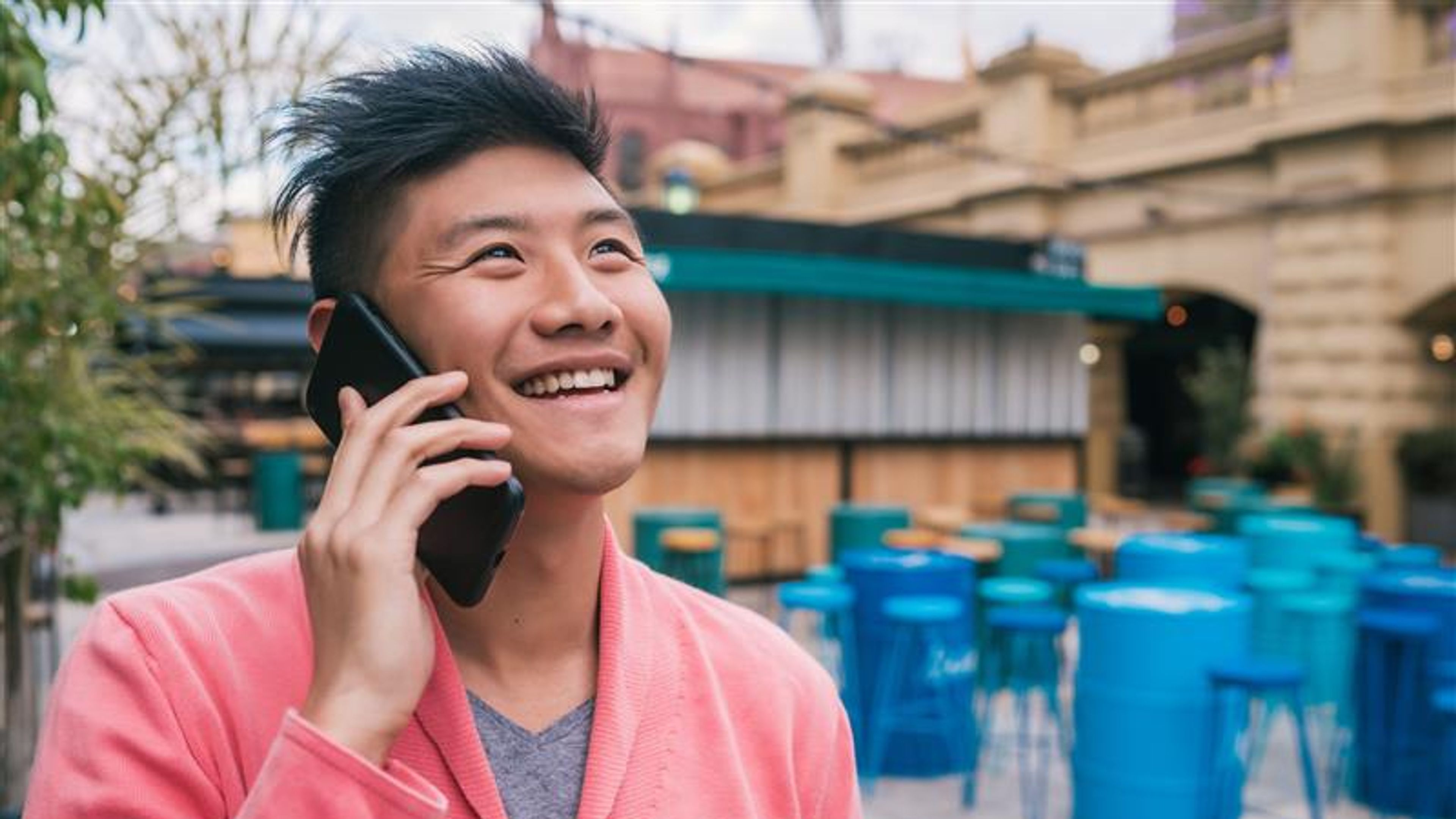 Asian man talking on the phone outdoors