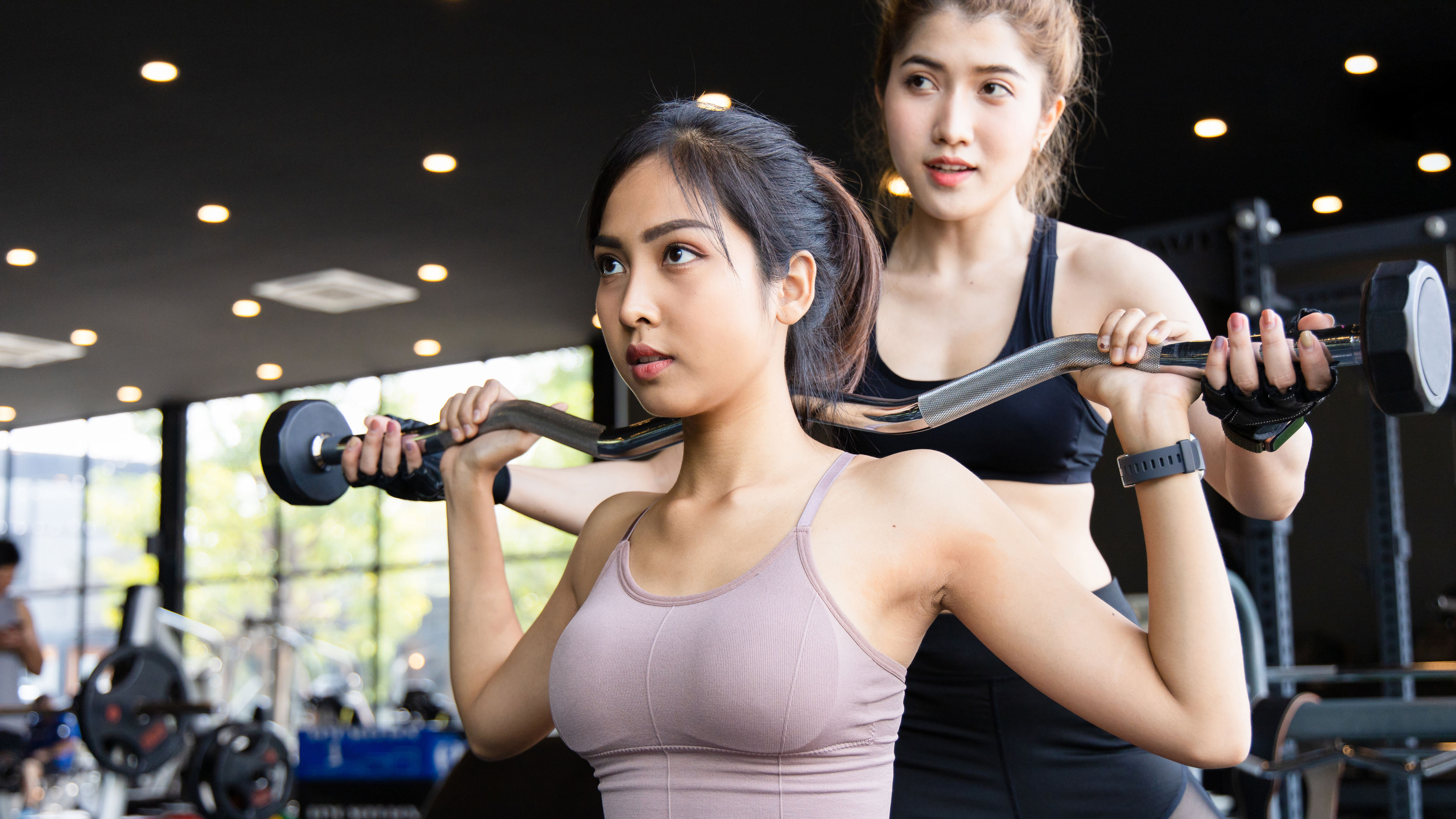 Attractive young sporty asian woman is workout in fitness gym