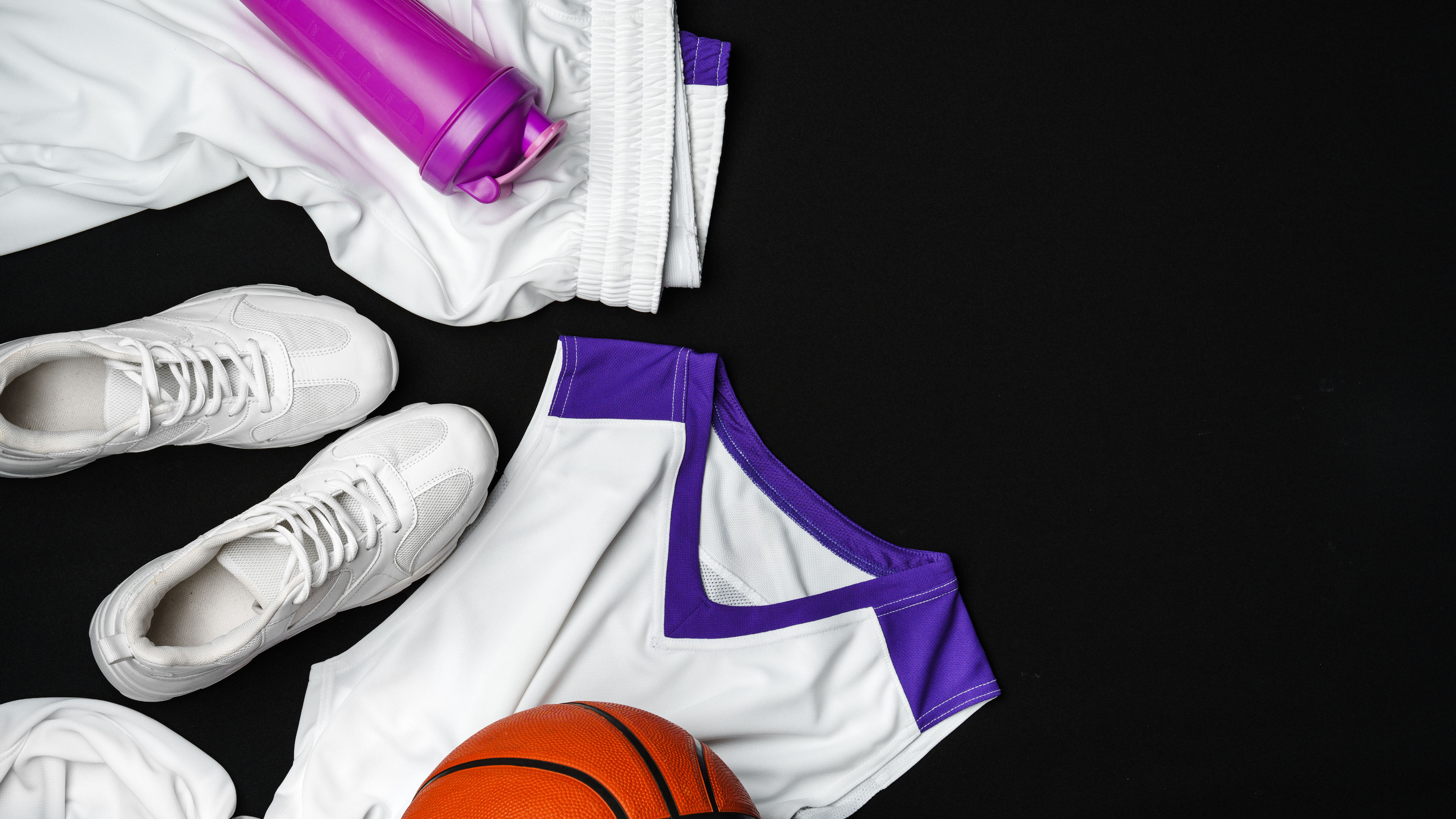 Basketball Gear Prepared for an Evening Training Session on a Dark Backdrop