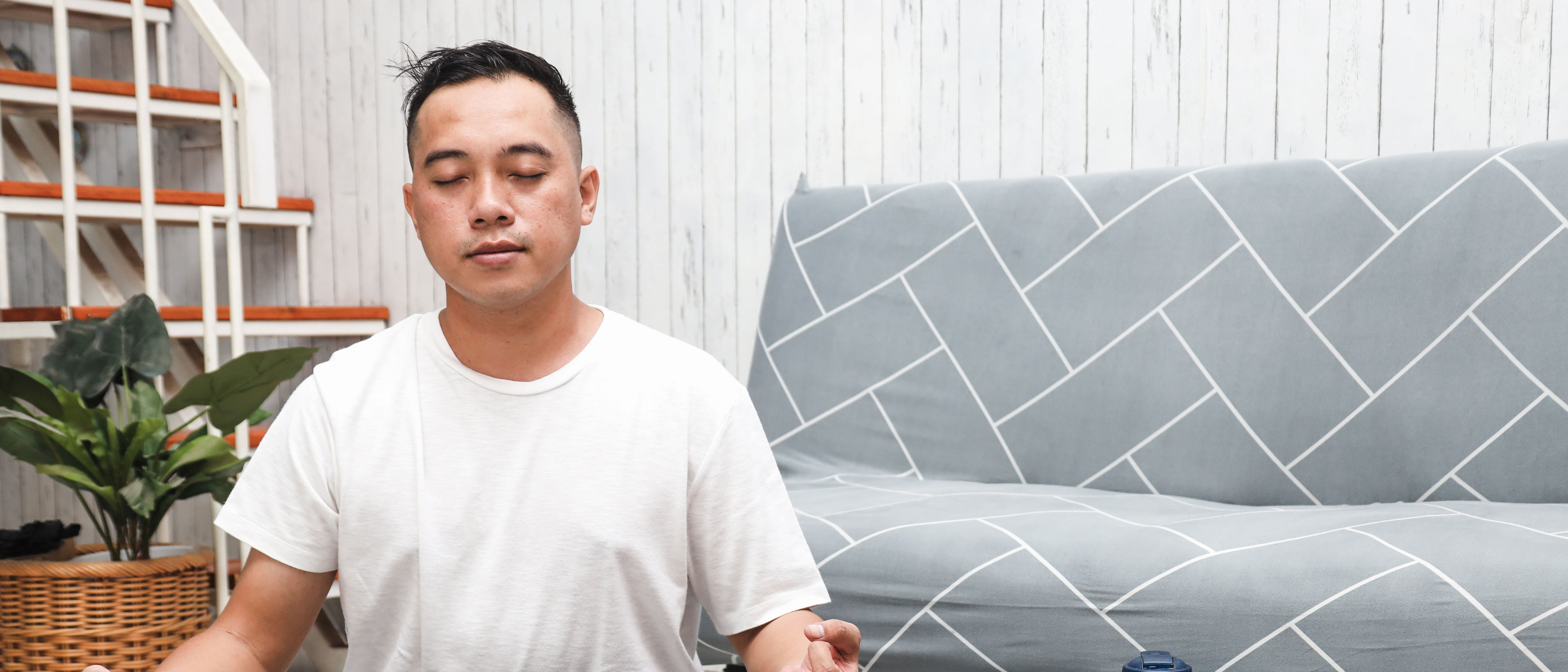 man practicing yoga at home