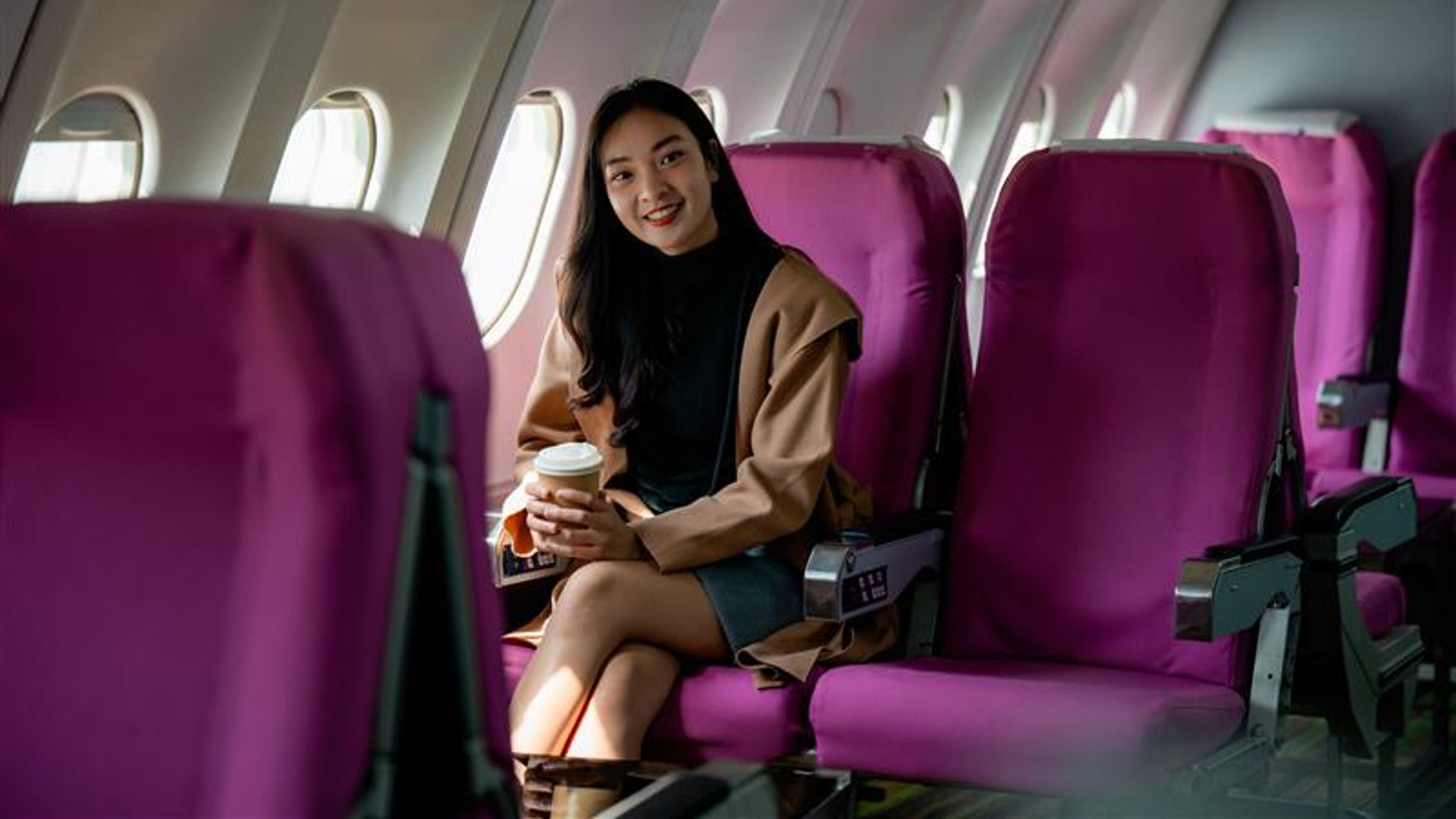 Professional executive sipping coffee, relaxing during business travel on a passenger jet