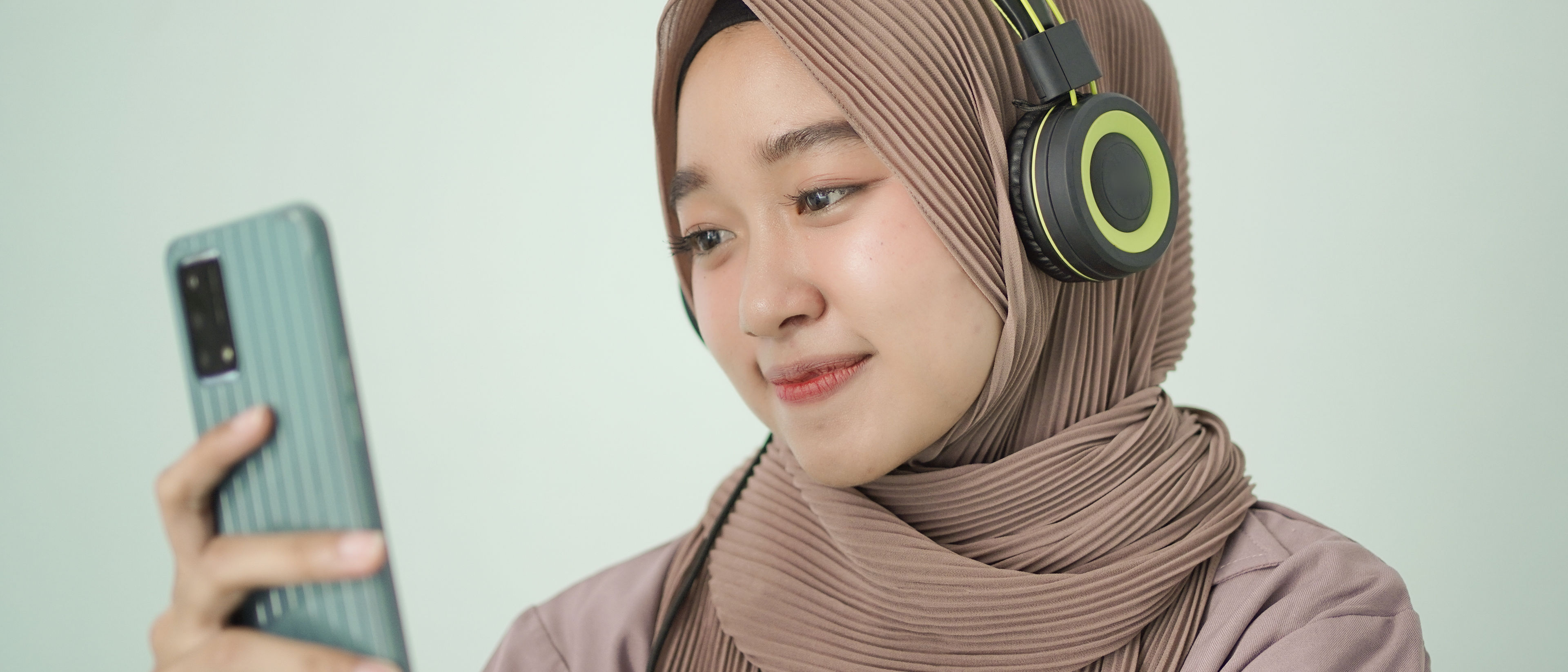 Woman is looking at her cellphone happily