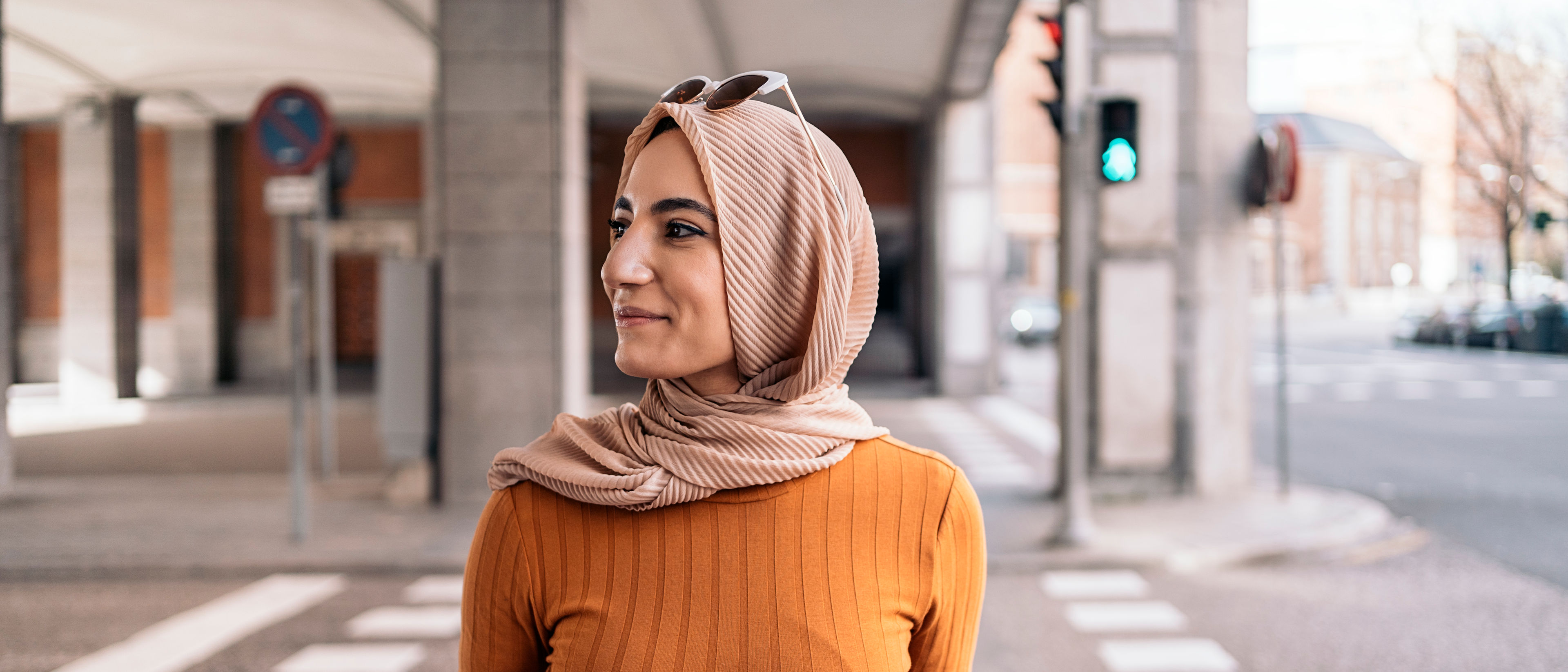 A woman wearing an orange top
